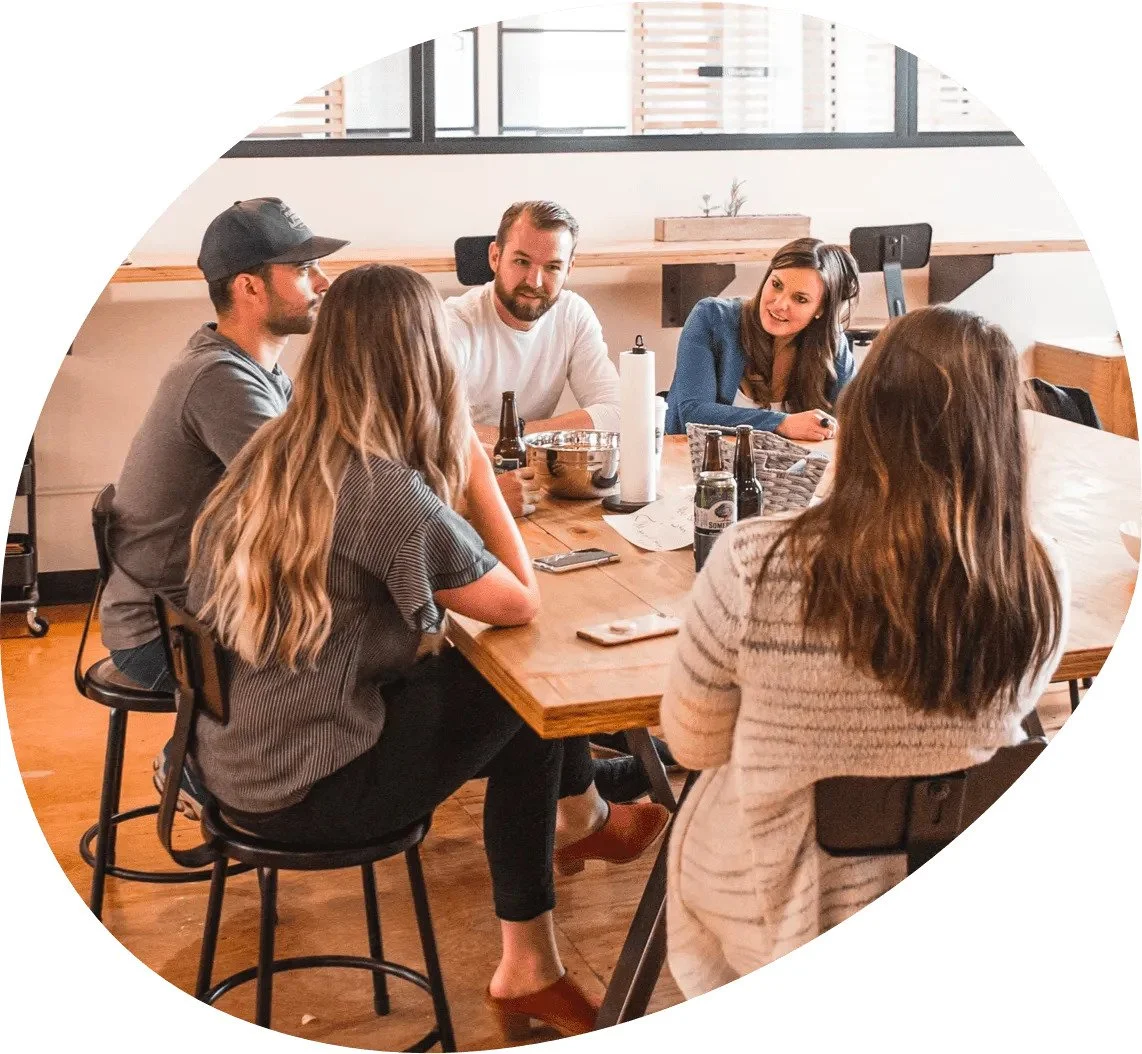 Co-workers seated around a table with drinks