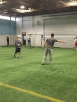 The coaches directing the goalies through a series of stations.