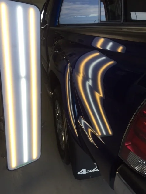 Blue truck panel before paintless dent repair