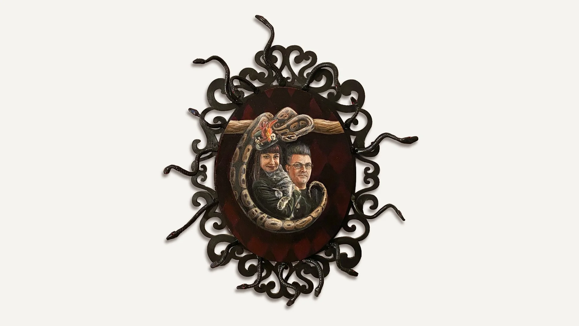 painting of a woman, a man, a cat, and a large boa constrictor with little snakes coming out of an ornate frame