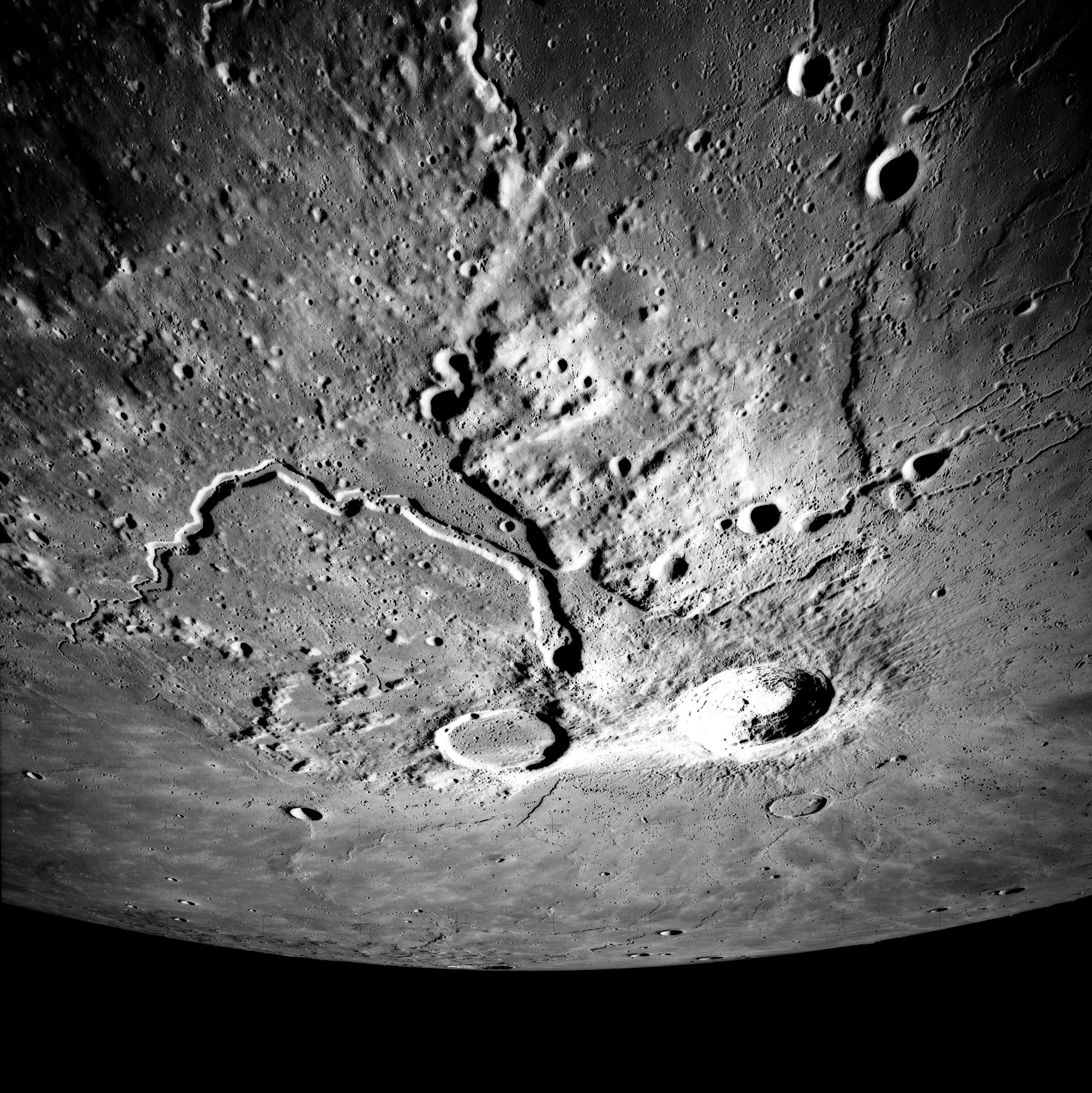 (Left) Apollo 15 Mapping Camera image (A15-M-2610) of the Aristarchus plateau. Note the large, fresh Aristarchus crater, as well as the sinuous rille Vallis Schroteri. The entire uplifted, hummocky plateau has been mantled by pyroclastic materials. (Right) Topography of the Cobra Head region of the plateau. All of the major volcanic features on the plateau (Cobra Head, Vallis Schroteri, the pyroclastic deposit, and the irregular cones) may have been formed from an eruptive vent located at Cobra Head. 