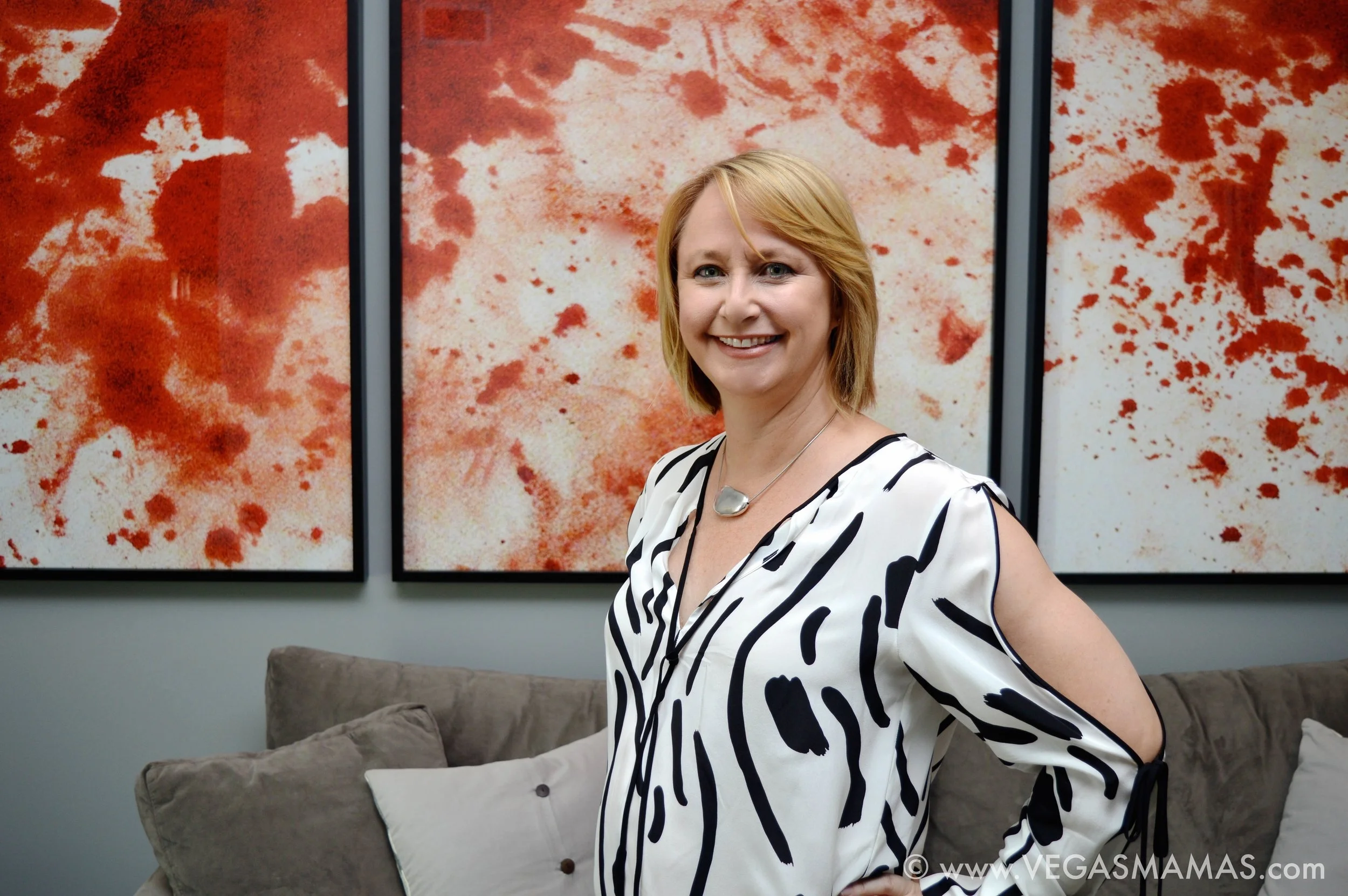 Michele pictured in her family room standing in front of the Blood triptych by artist Kevin Lynch, for a larger project commissioned for childhood friend and client, Lorenzo Fertitta, former UFC owner. The OCTAGON project documented the first five years of the life of UFC. Kevin Lynch, Blood , 2007, Chromogenic print mounted on Dibond 50 x 40 inches, Edition of 8