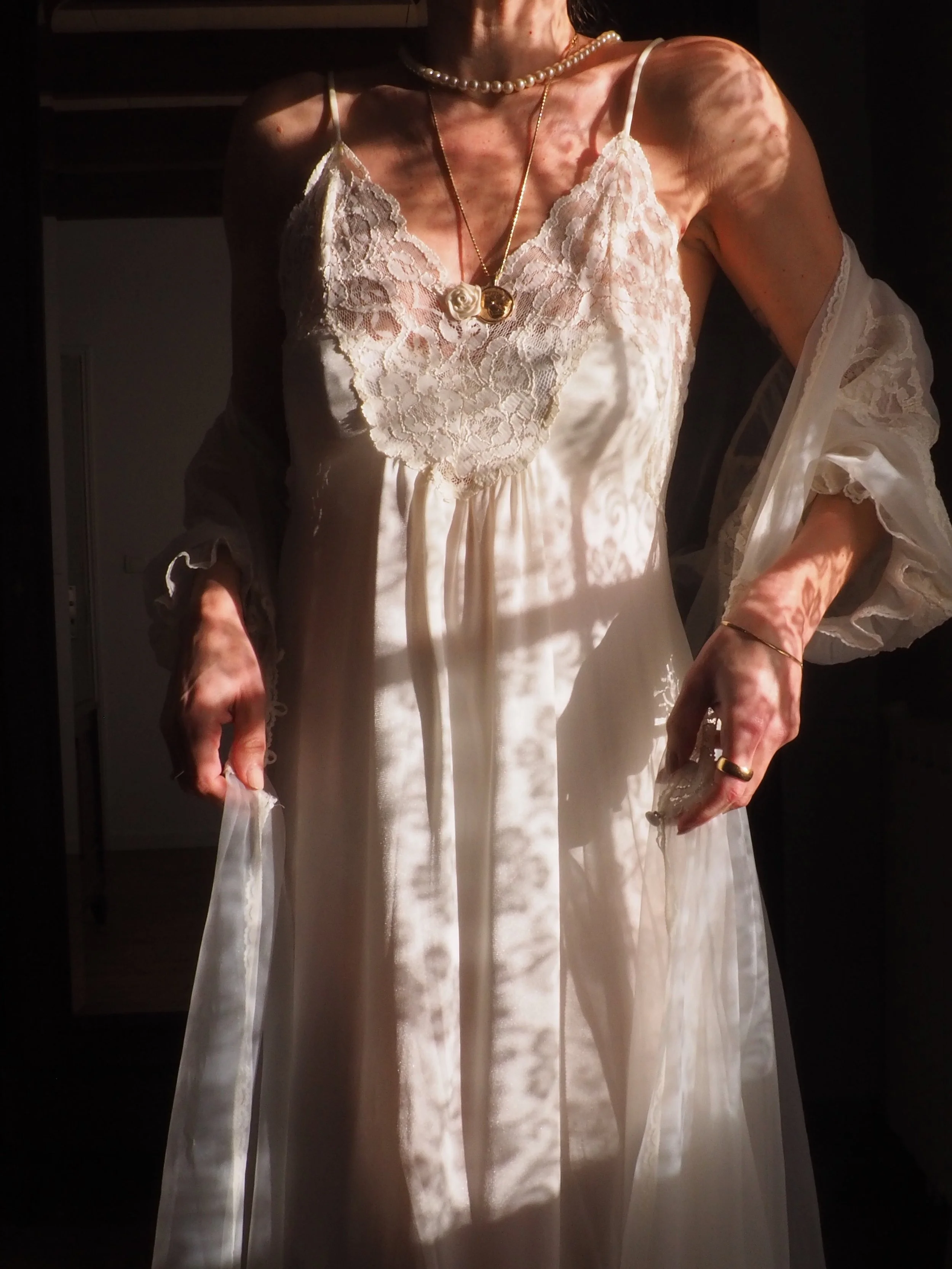 Model wearing black dress and diamond necklace