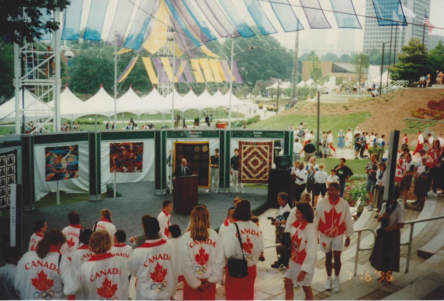 A photo from the personal collection of Mary Ross, during the quilt presentation ceremony she was invited to. Her quilt was given to the flag-bearer of Canada. Quilters were invited to these ceremonies, which was a big deal, because access to the city and the Games was rare. Her quilt is below.