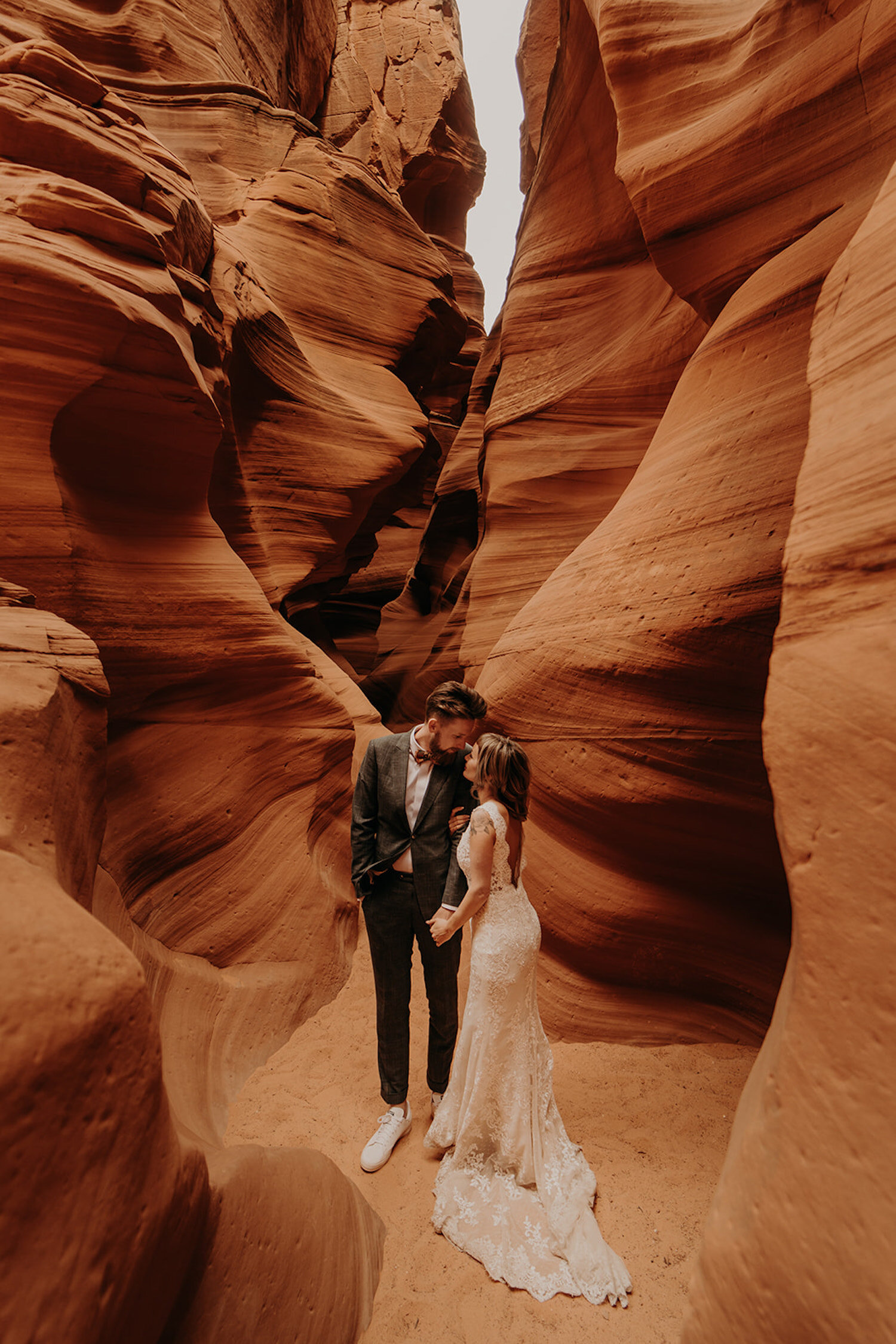 Bride and groom pose together in the canyon of Antelope Canyon during their Arizona elopement