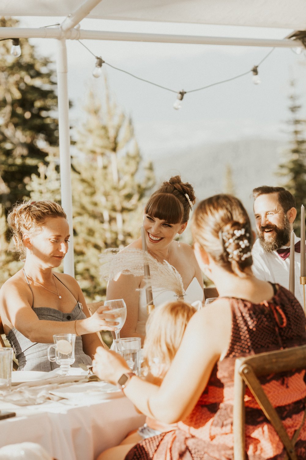 Bride and groom laugh during their Promise Mountain Destination Wedding Reception