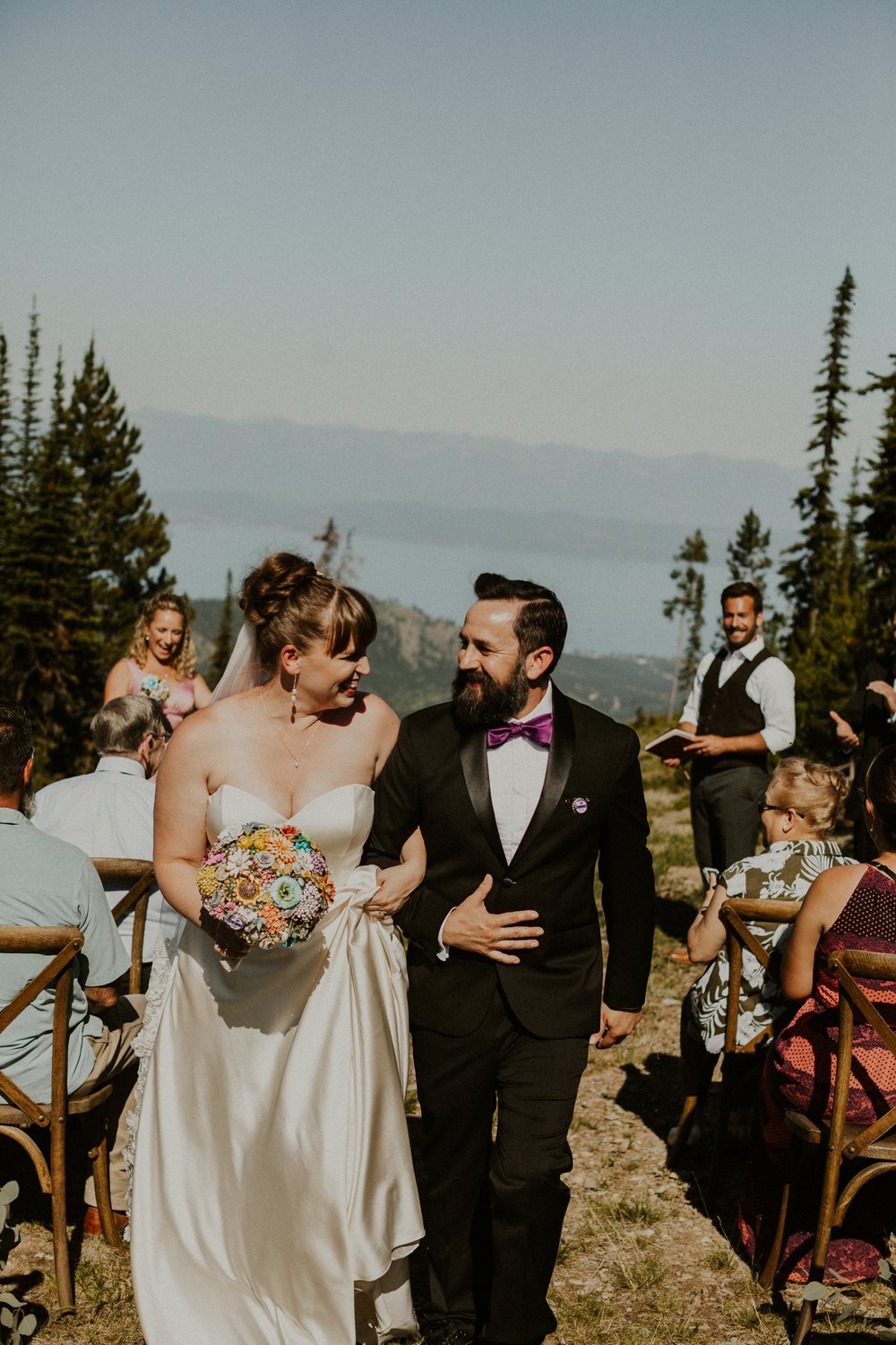 Bride and groom walking back down the aisle with their wedding guests looking on