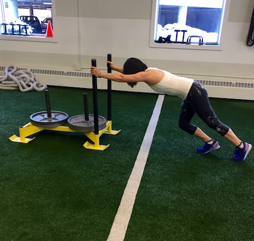 Veteran client Elinor crushing sled pushes at Pure Performance Training this past month.