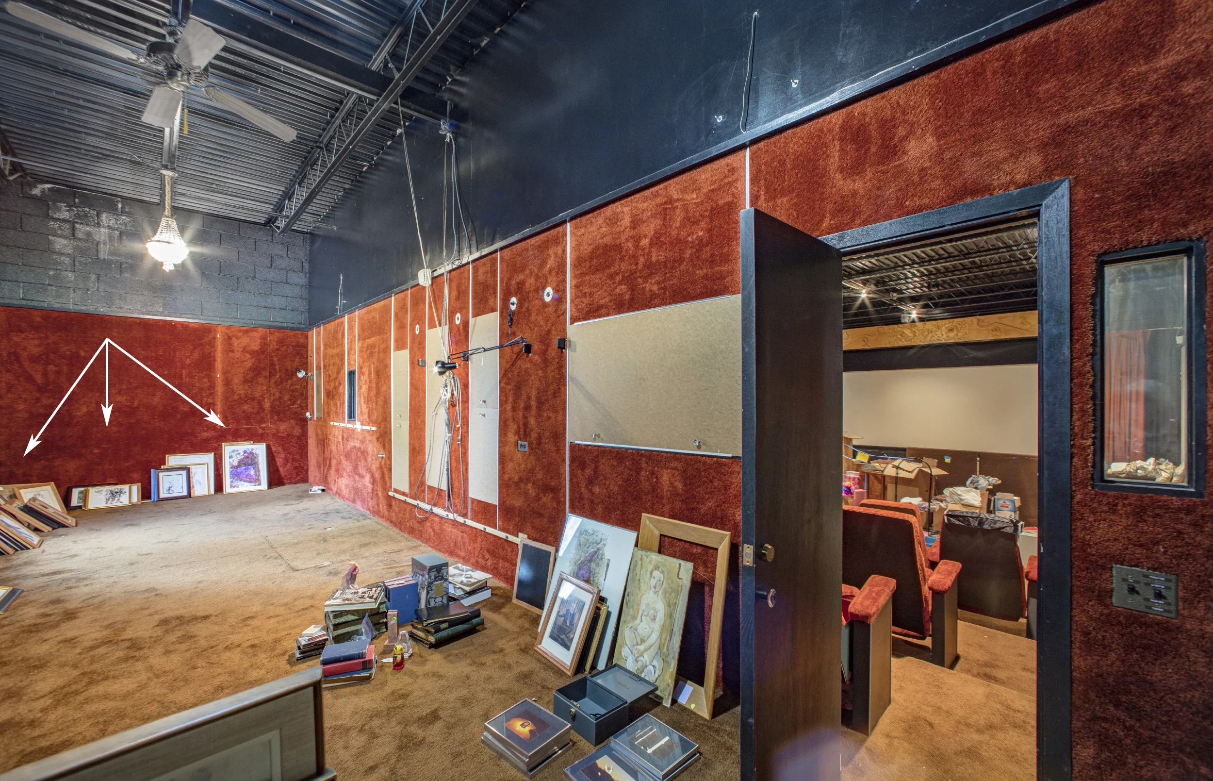 Rosenblum Residence, Looking from projection booth into screening room. Arrows indicate the location of collection as found in situ.