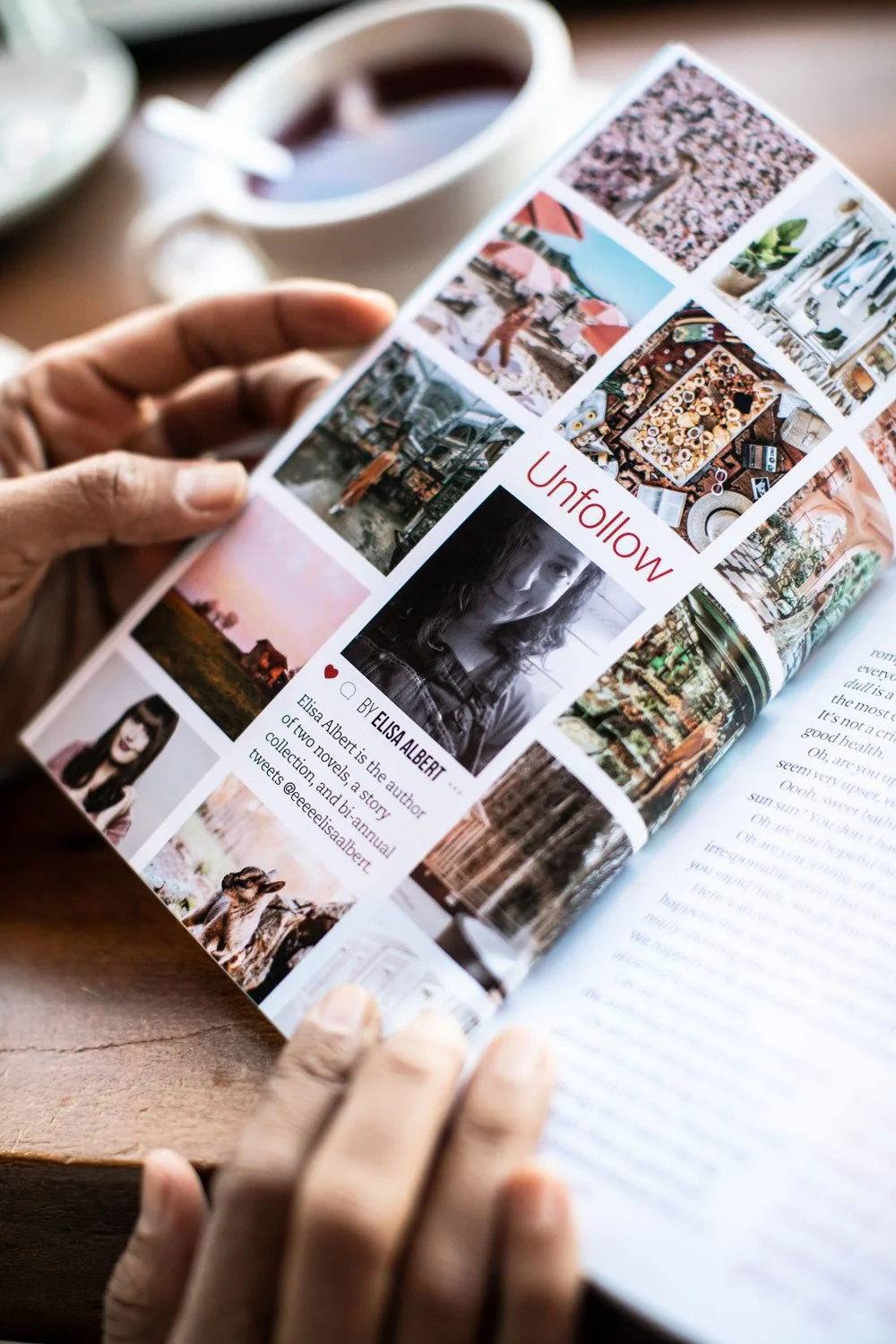 Person holding a magazine or brochure with various colorful photographs and a black-and-white portrait of a woman, with the word 'Unfollow' in red text. A cup of coffee or tea is in the background.
