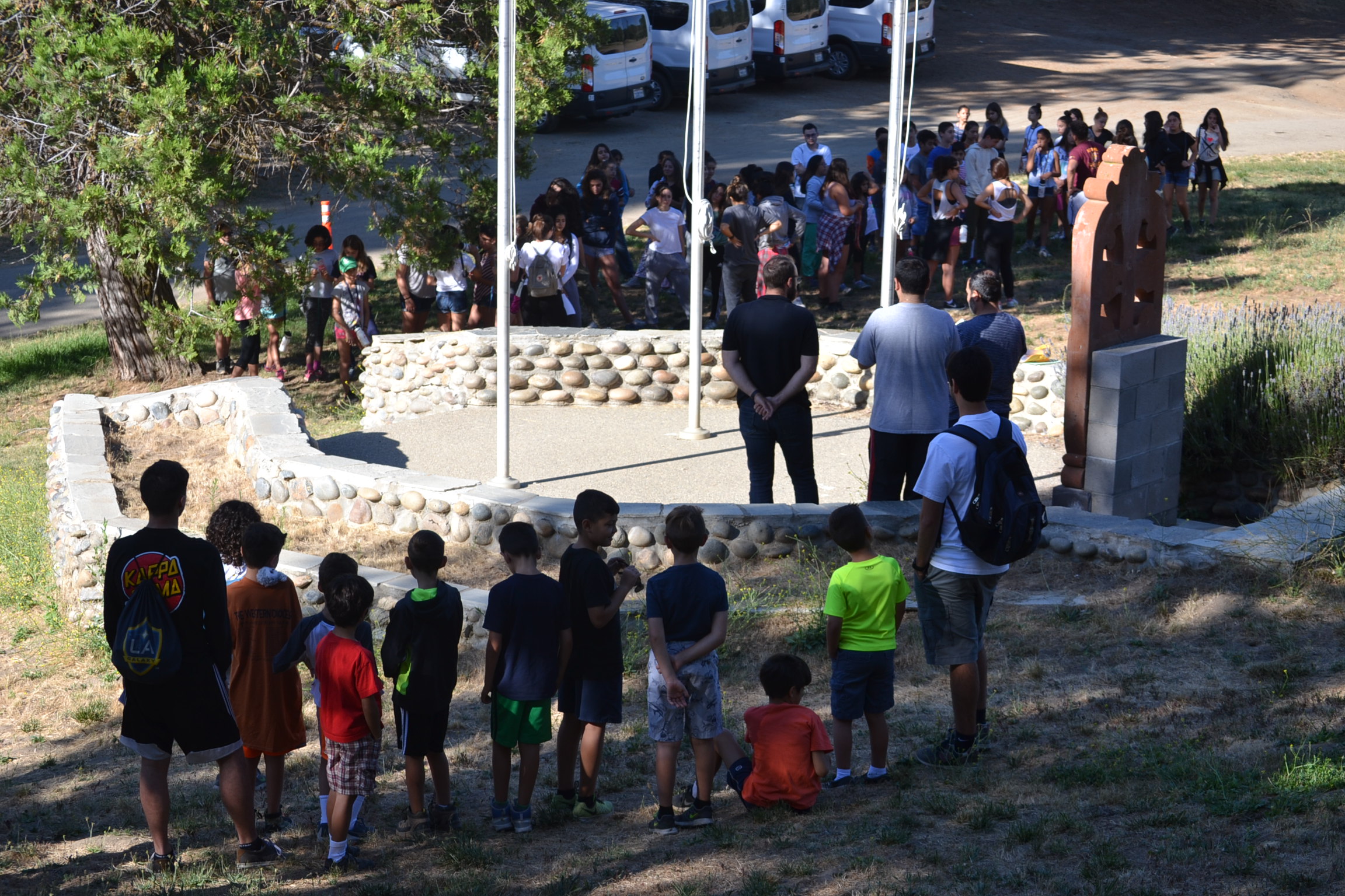 Our chaplains, Der Hovel and Der Mesrop with Dn, Hayk leading a morning chapel at the flagpoles.