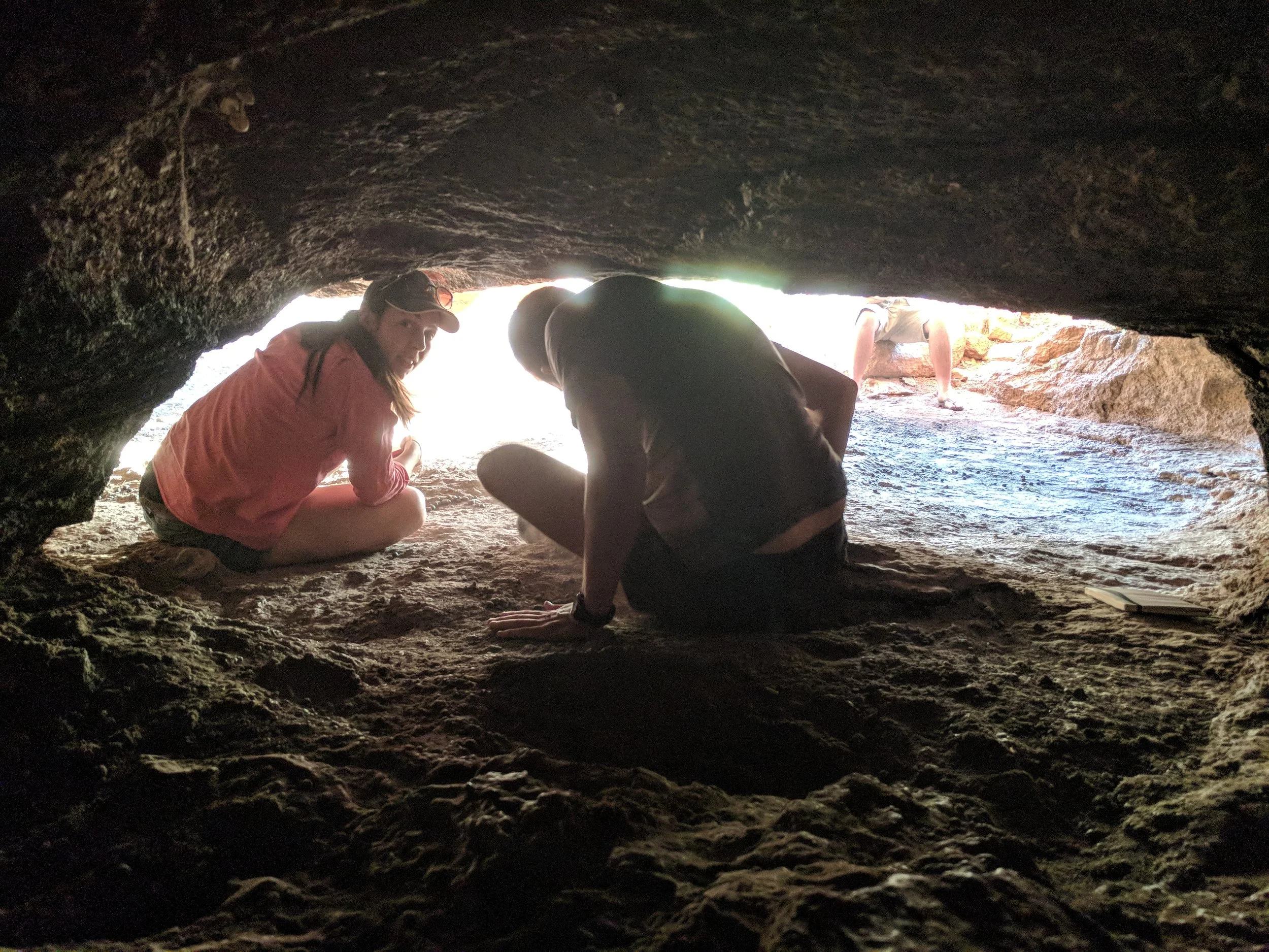 Frances and Owen climbing out of a cave on Budara. Owen is thinking that he should have thought about how to get out before moving.