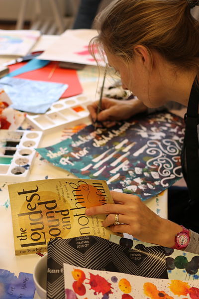 Woman writing in ink using calligraphy techniques