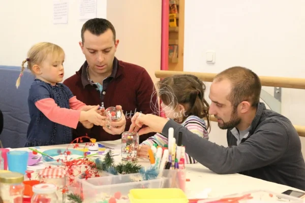 Dads and their kids making Christmas arts and crafts together
