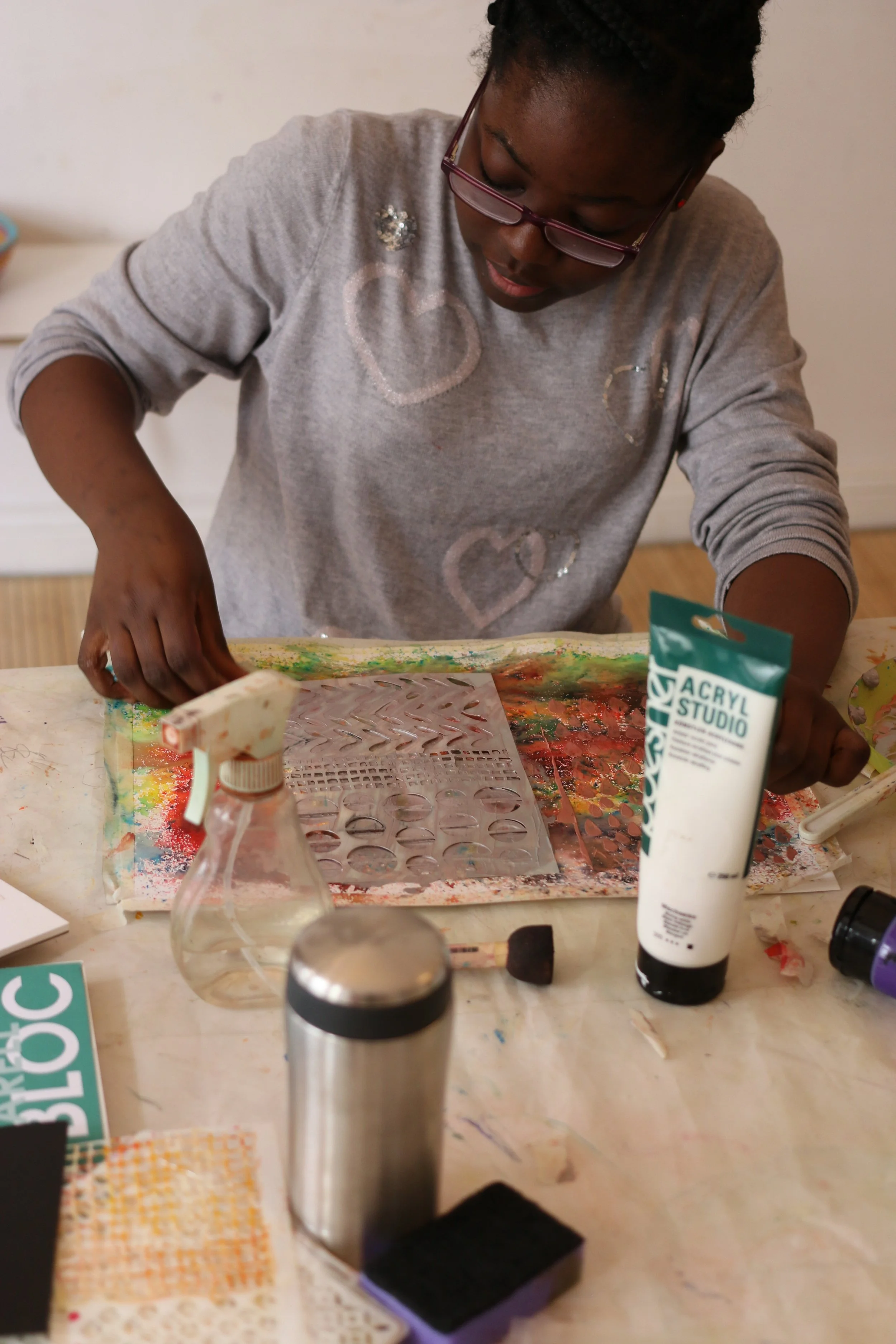 Child working on an art project using stencils