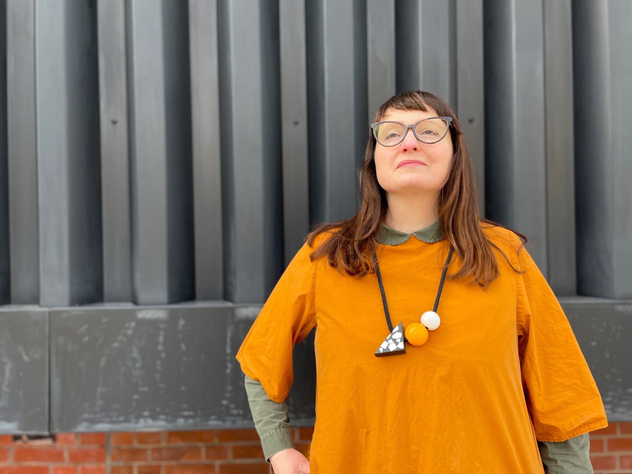 Female Creative Life Coach standing smiling in the sun