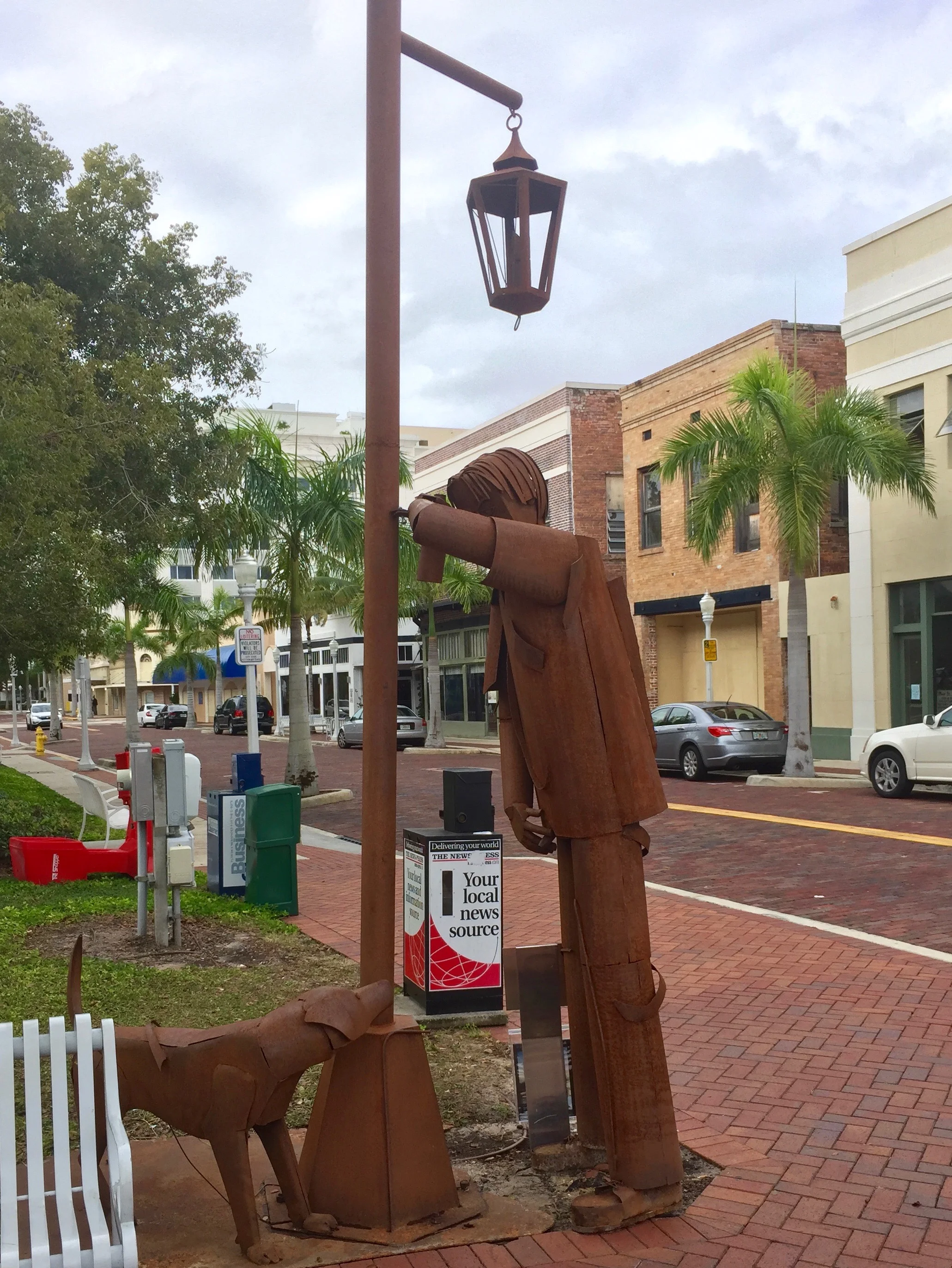 This piece, "Territorio", has caused something of a stir lately. It's part of an installmant of a couple dozen sculptures by Colombian artist Edgardo Carmona that form a temporary exhibition scattered throughout downton Fort Myers. It's described as "Two parallel scenes: Irony of the dog 'marking his territory' the same way the man does by leaning against the light pole."
