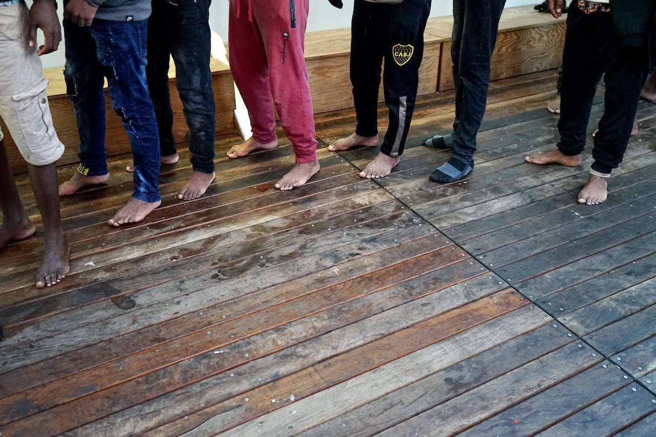 Survivors waiting in line on board of Ocean Viking, many arriving without any shoes. 