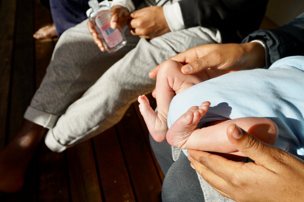 A sunny moment for the youngest survivor and his mother. 