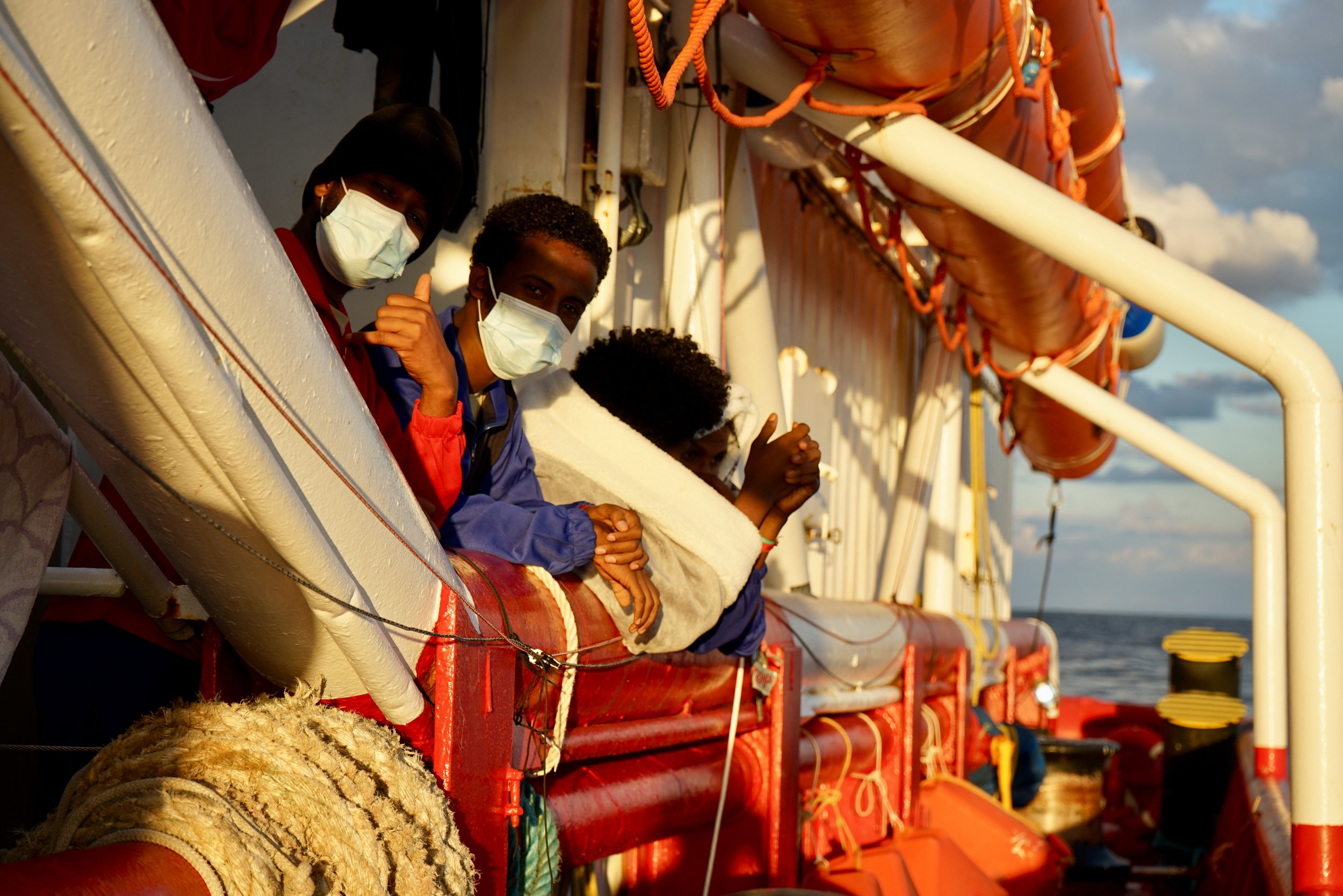 Survivors are looking at the sea onboard Ocean Viking.