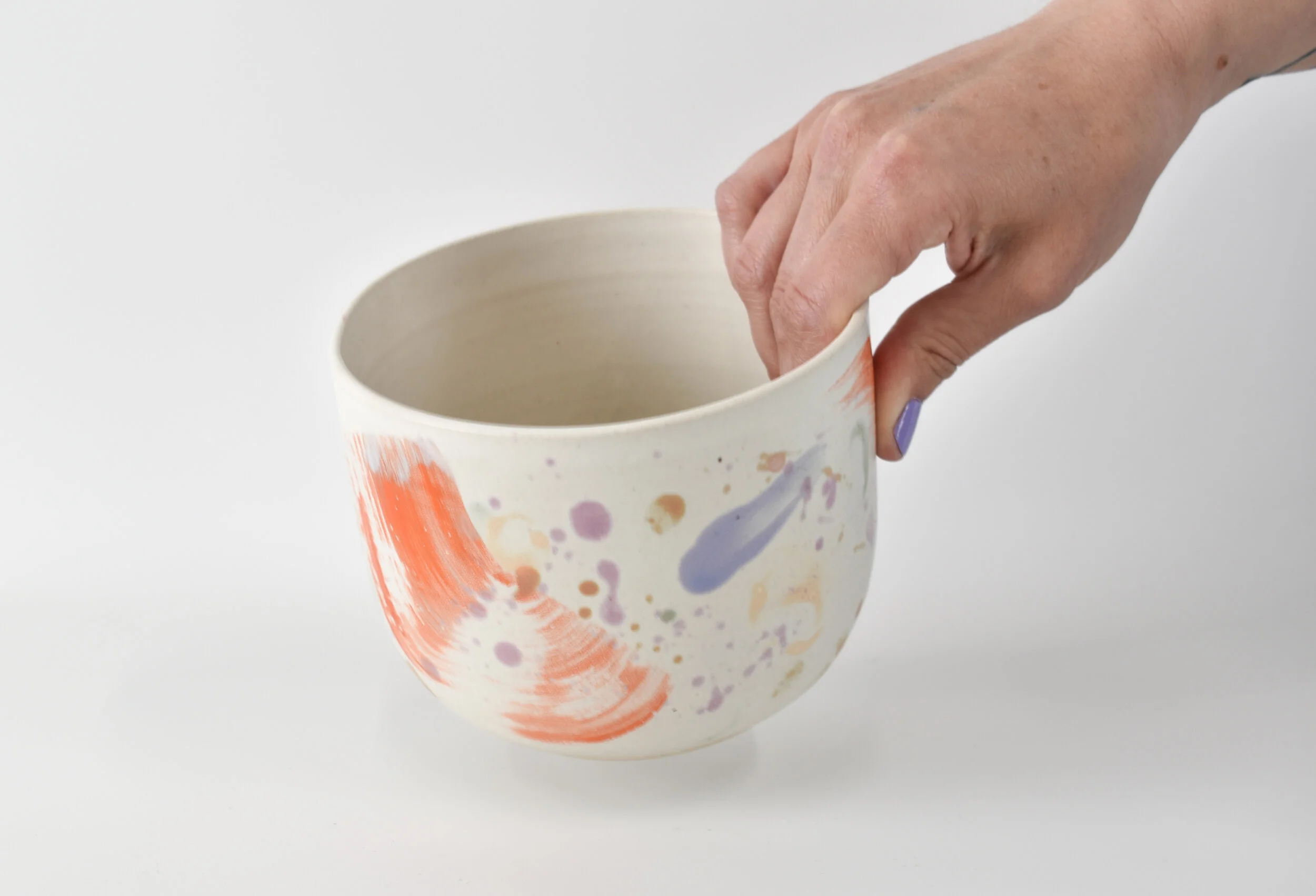Orange Splatter Bowl Hand 2.jpg