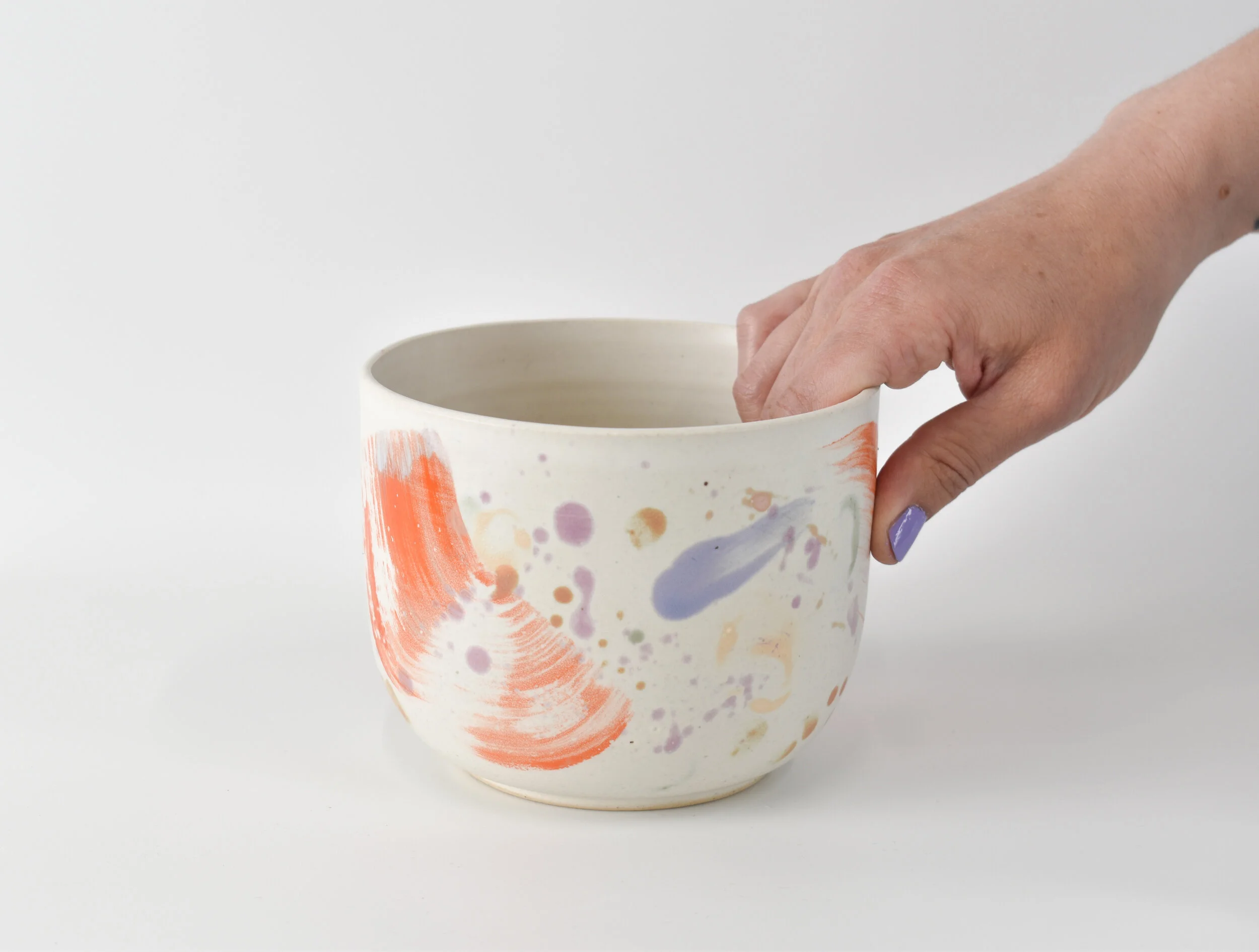 Orange Splatter Bowl Hand.jpg