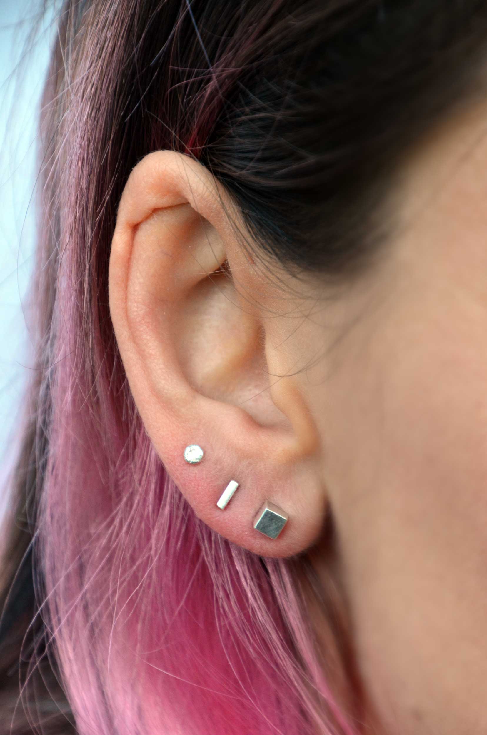 mix and match silver ear studs on model