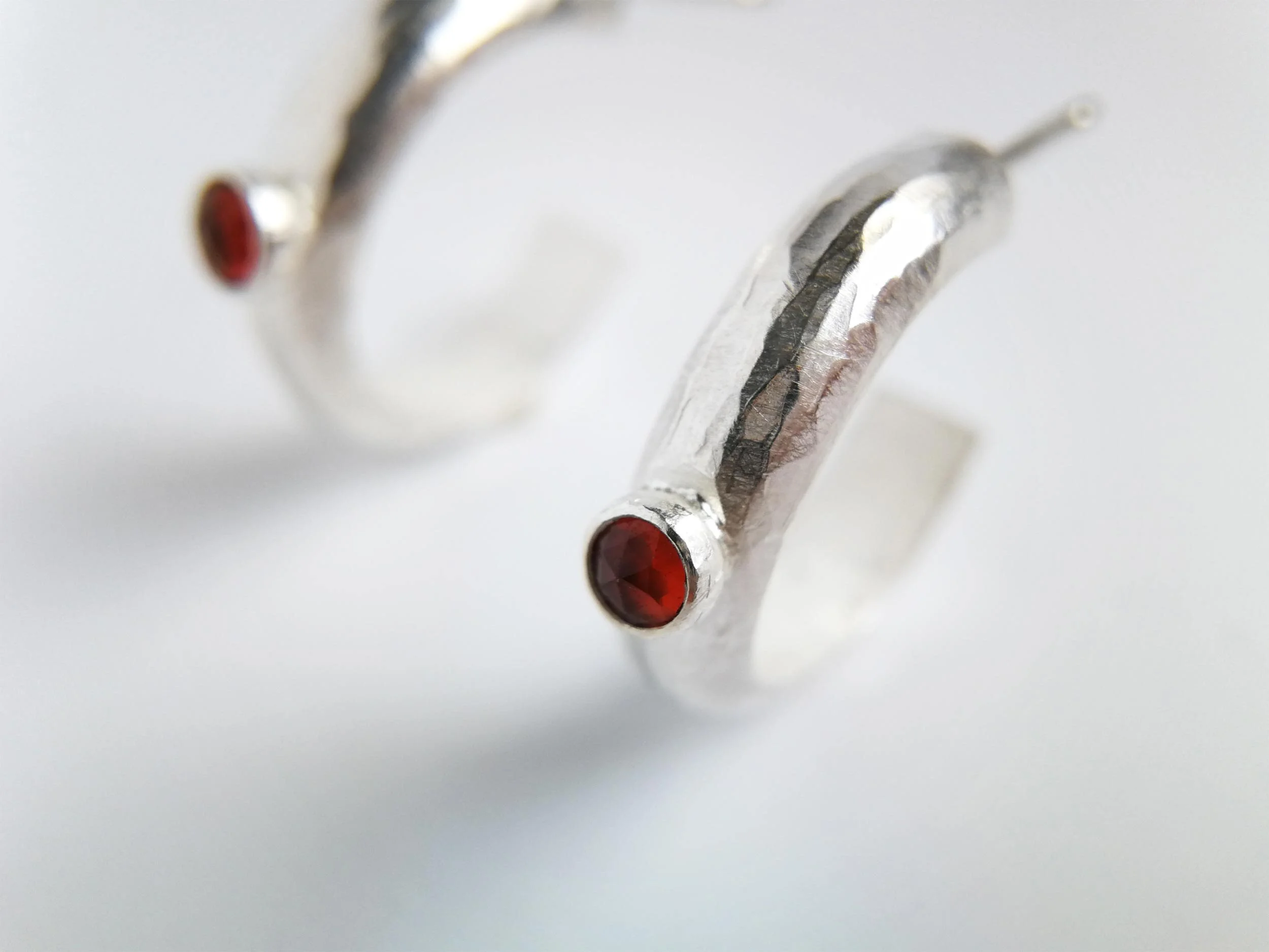 red garnet gemstone earring close up white background handmade