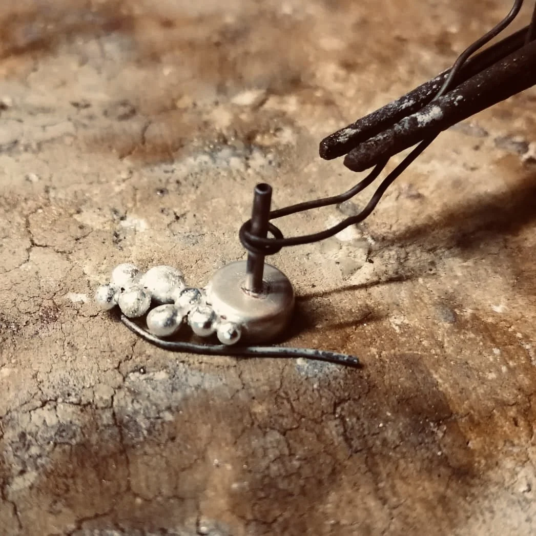 soldering a conch earring at the jewellery bench (Copy)