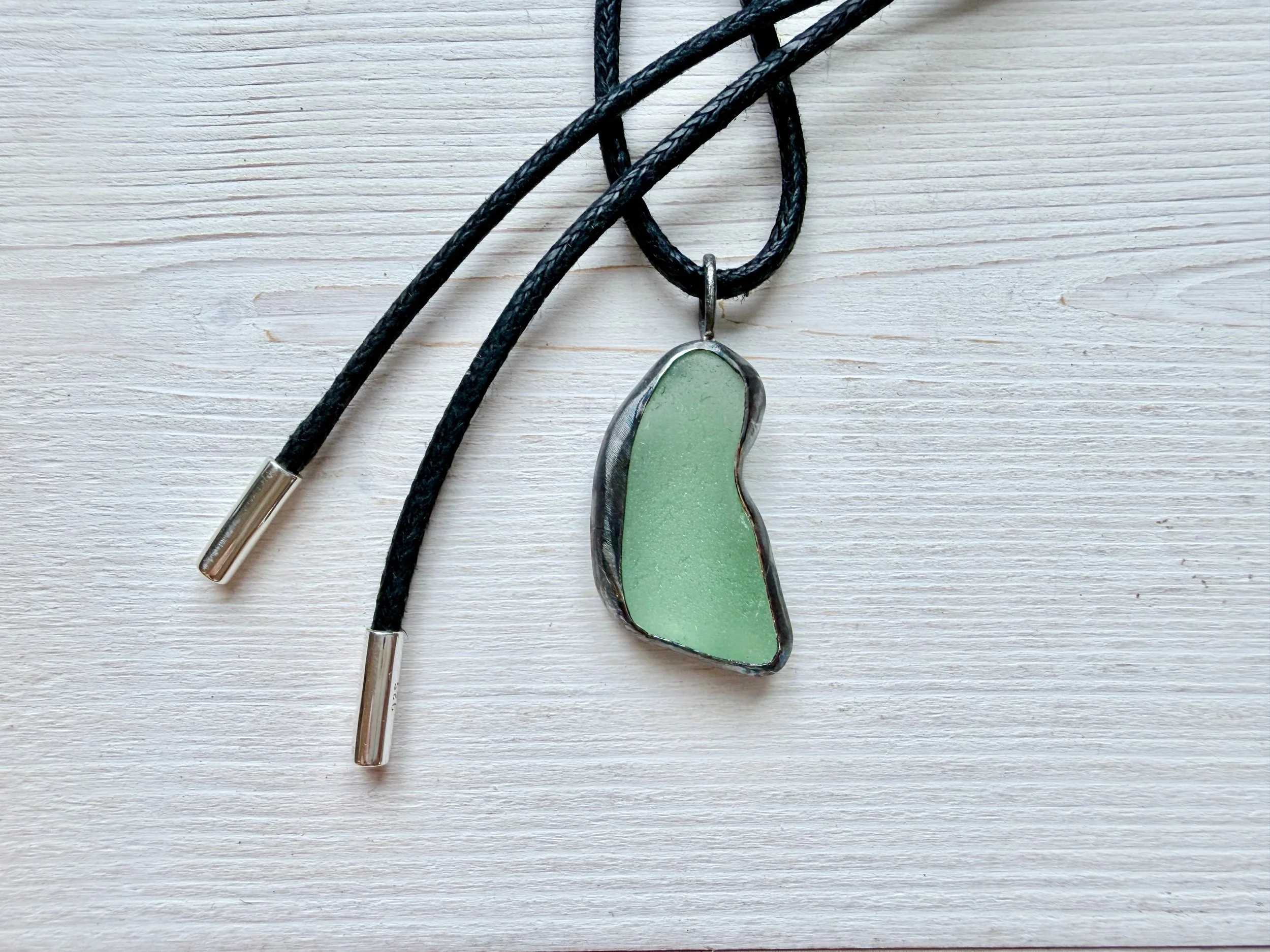 sea foam green handcrafted cornish seaglass pedant on black cotton cord