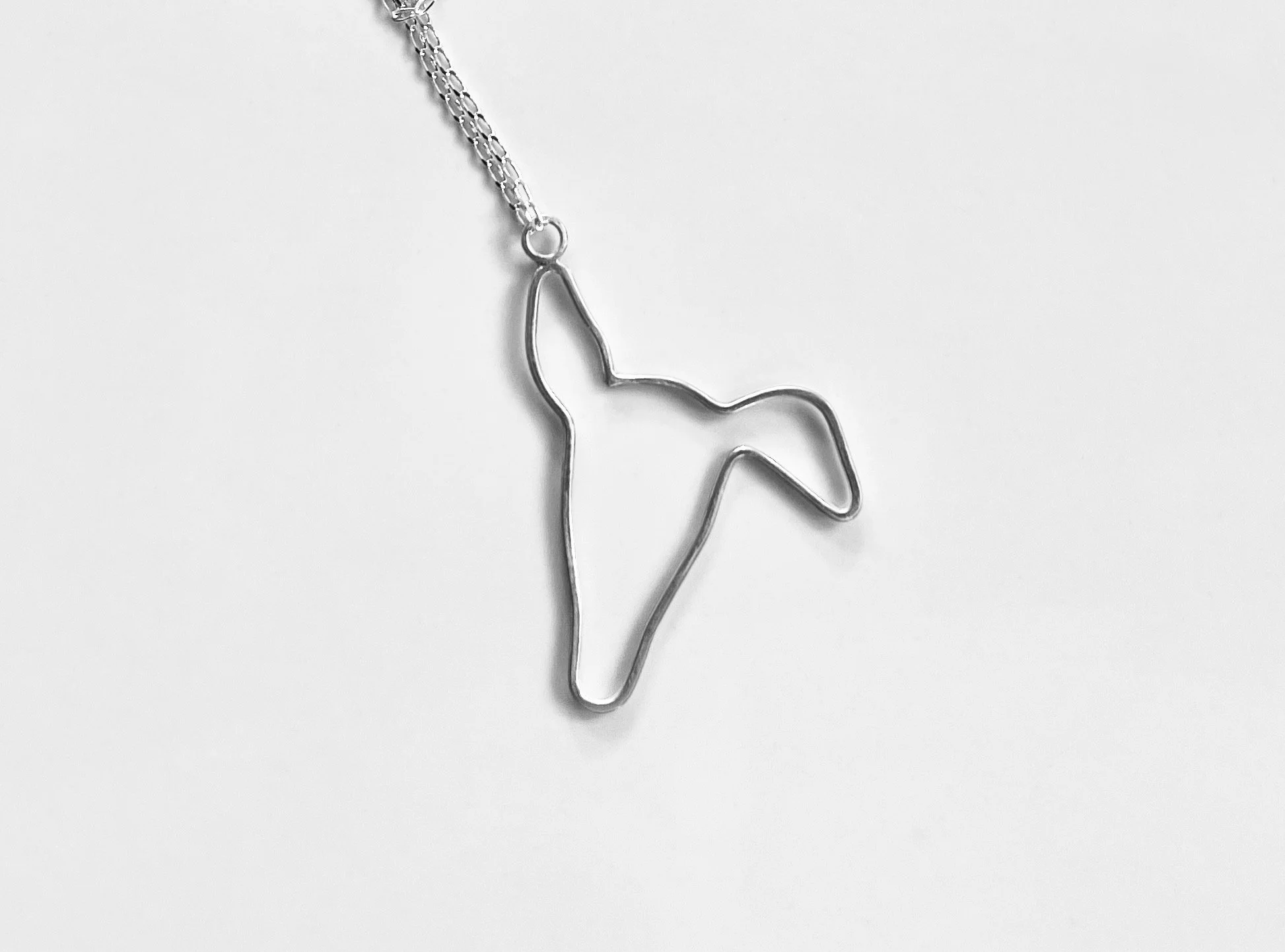Handcrafted recycled sterling silver greyhound silhouette pendant with a brushed satin finish.