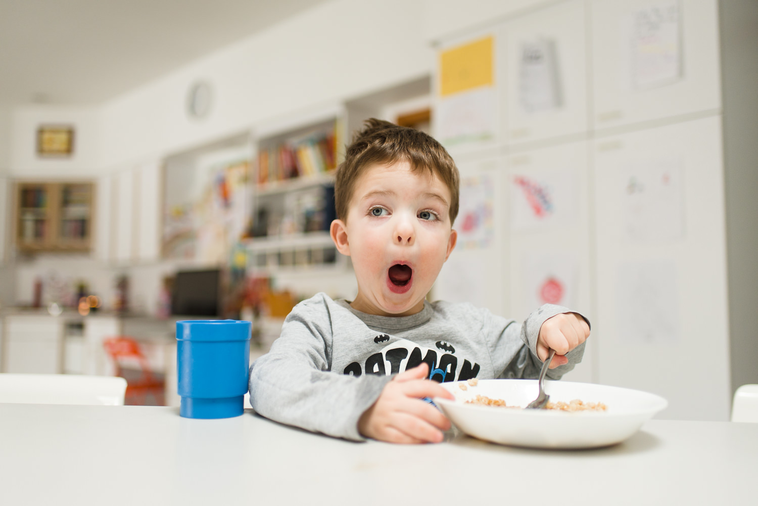 boy eating oatmeal at the kitchen counter