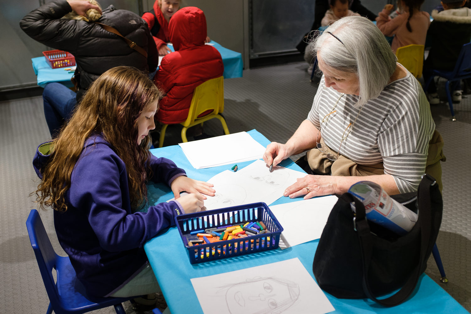 girl and grandma drawing portraits in Crayola Store Kansas City