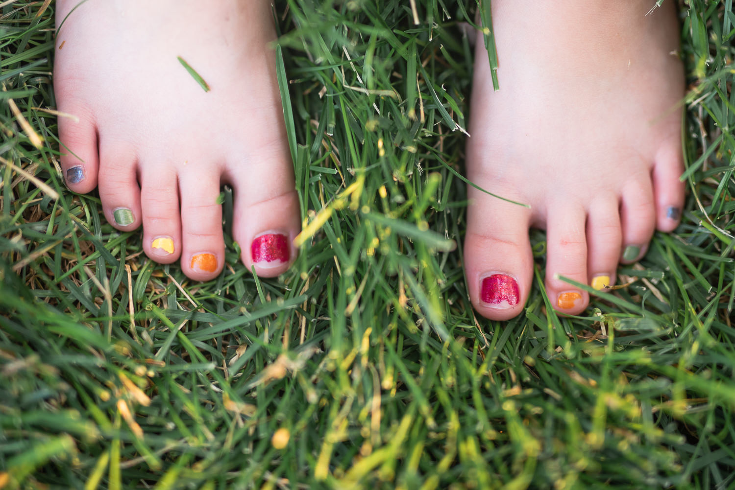 chipped rainbow pedicure little girl in Lincoln Nebraska.jpg