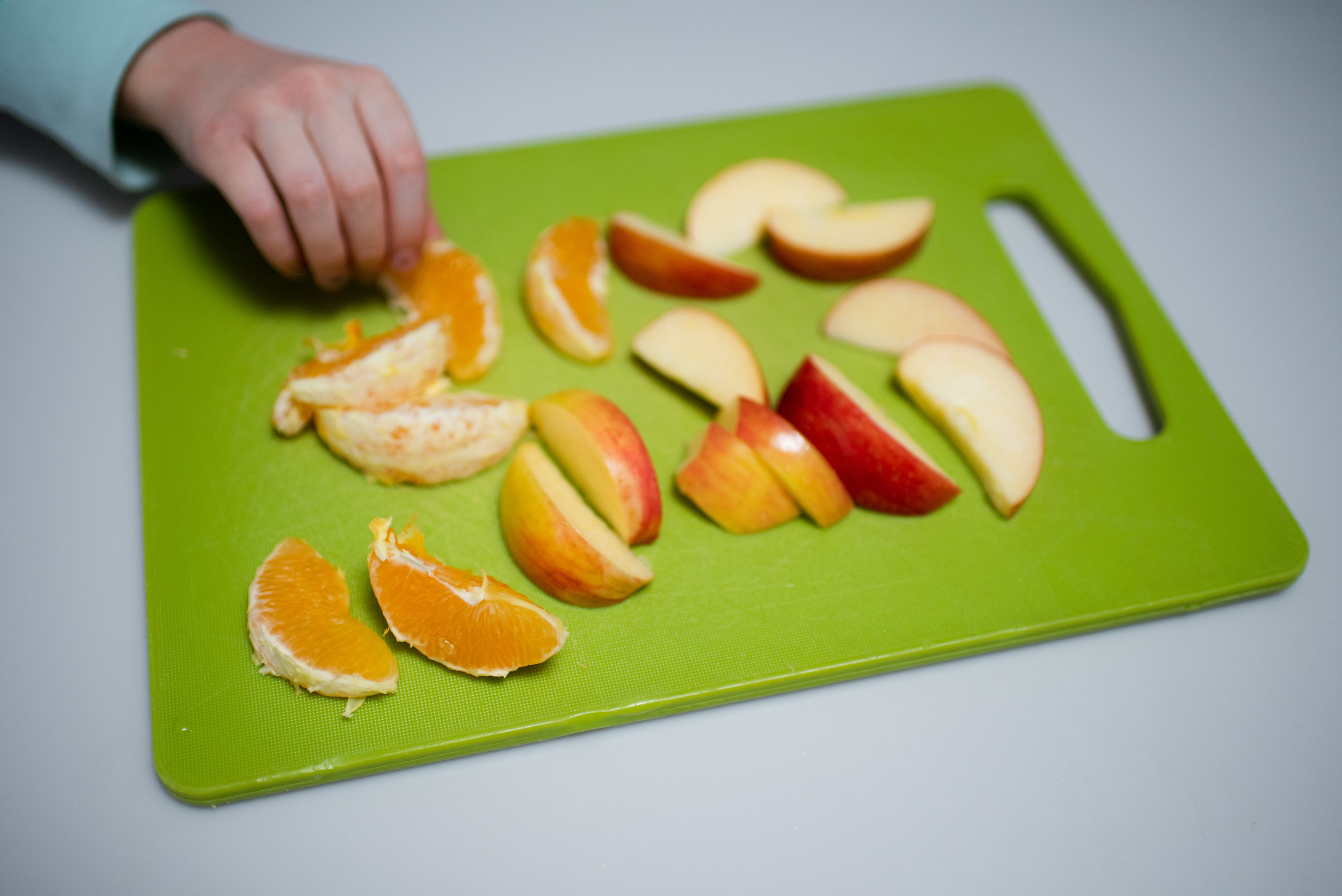 apple and orange sliced on cutting board.jpg