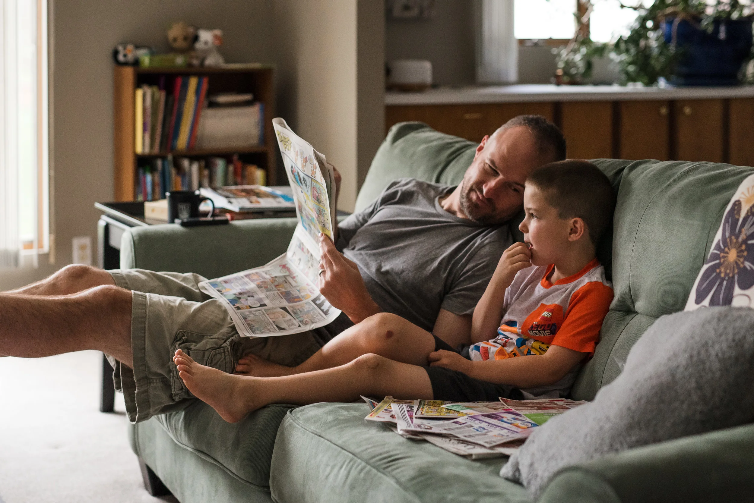 little boy and father reading the sunday newspaper together.jpg