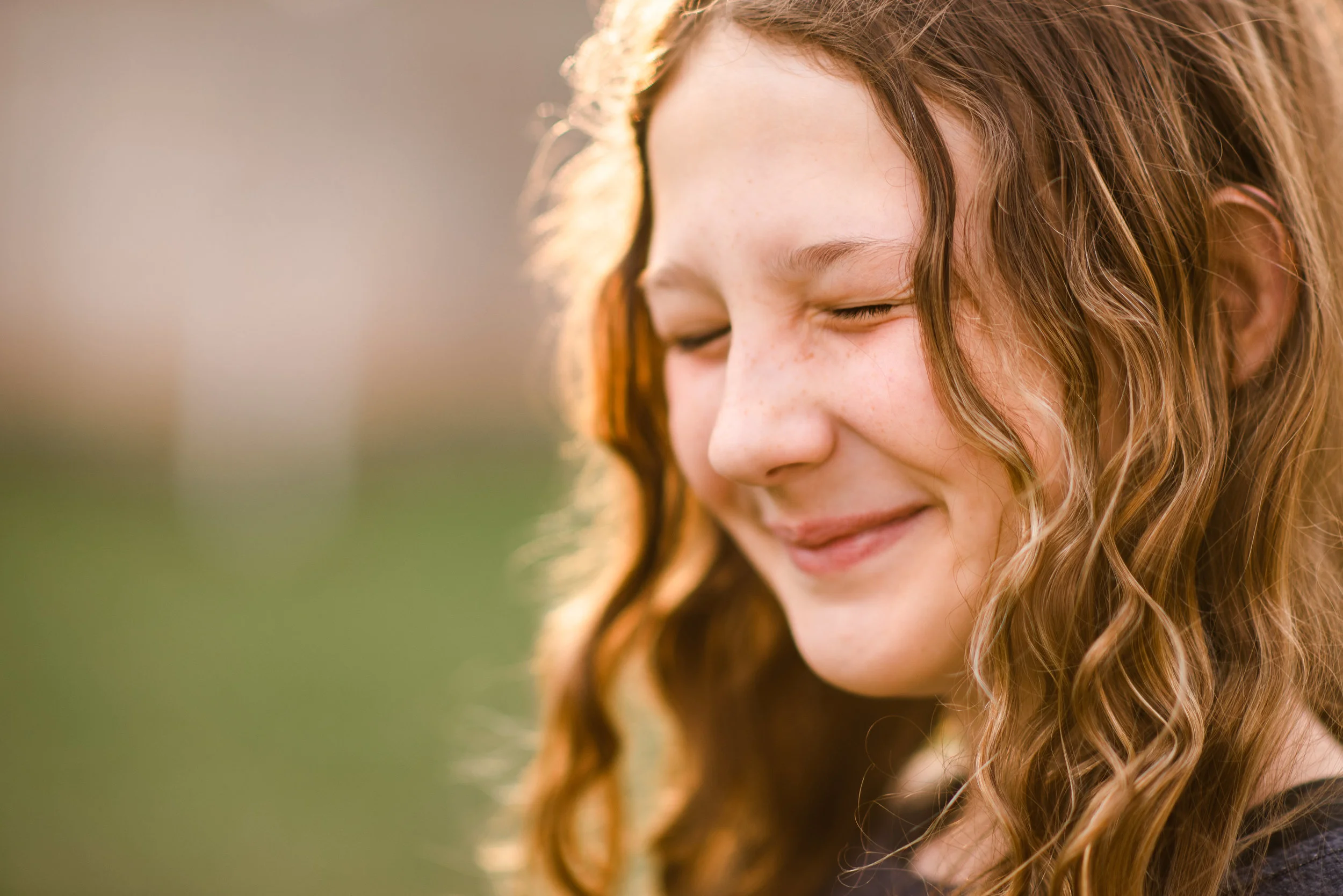 tween girl with curly hair squinting_.jpg