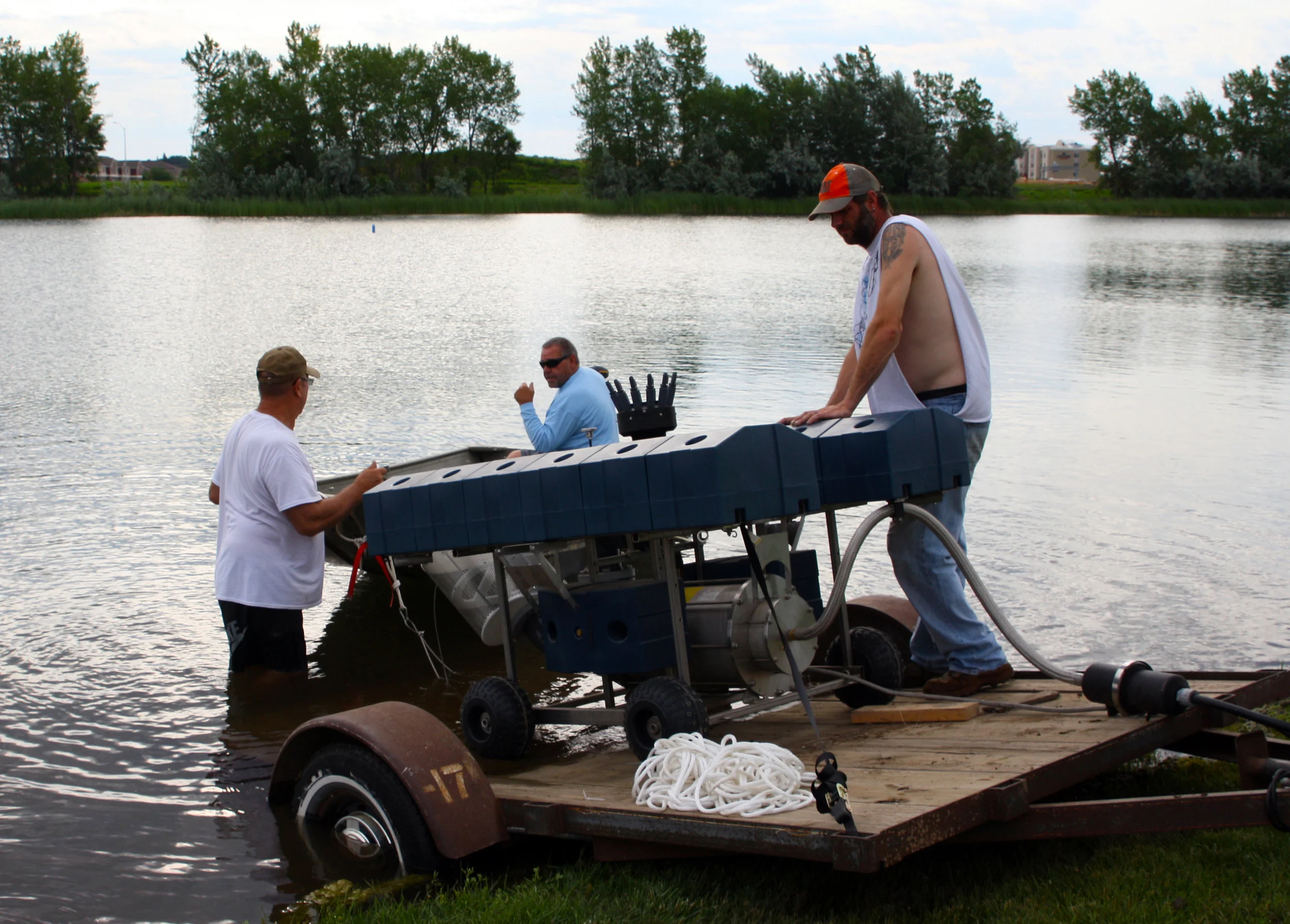 Friessen Construction employees load the fountain into Lake Lorraine.
