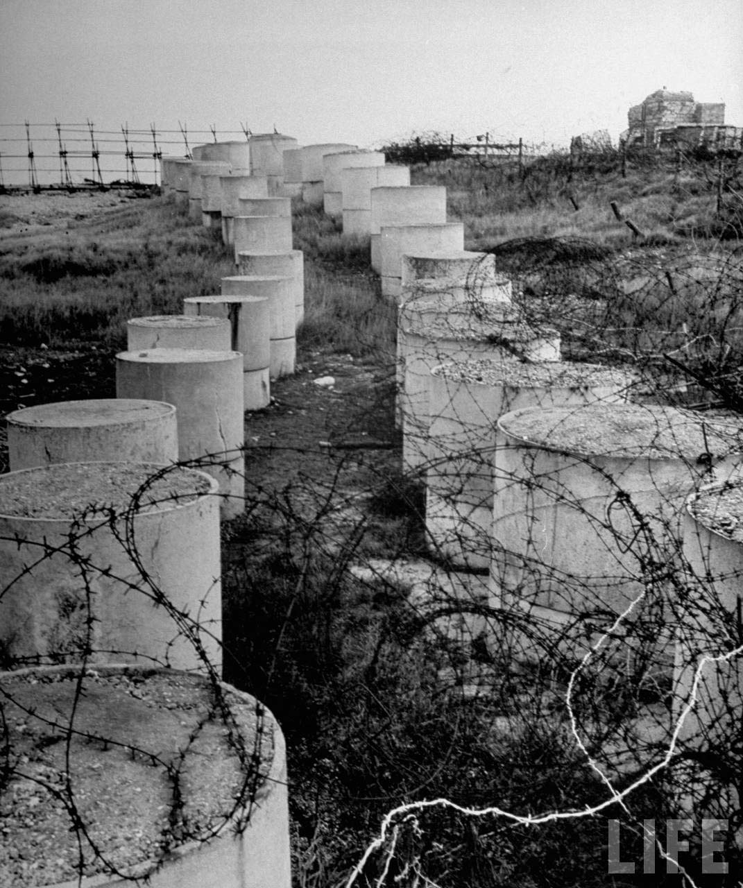 Cement anti-tank barrier shrouded with barbed wire. Eliot Elisofon, 1945 from LIFE magazine © Time, Inc.