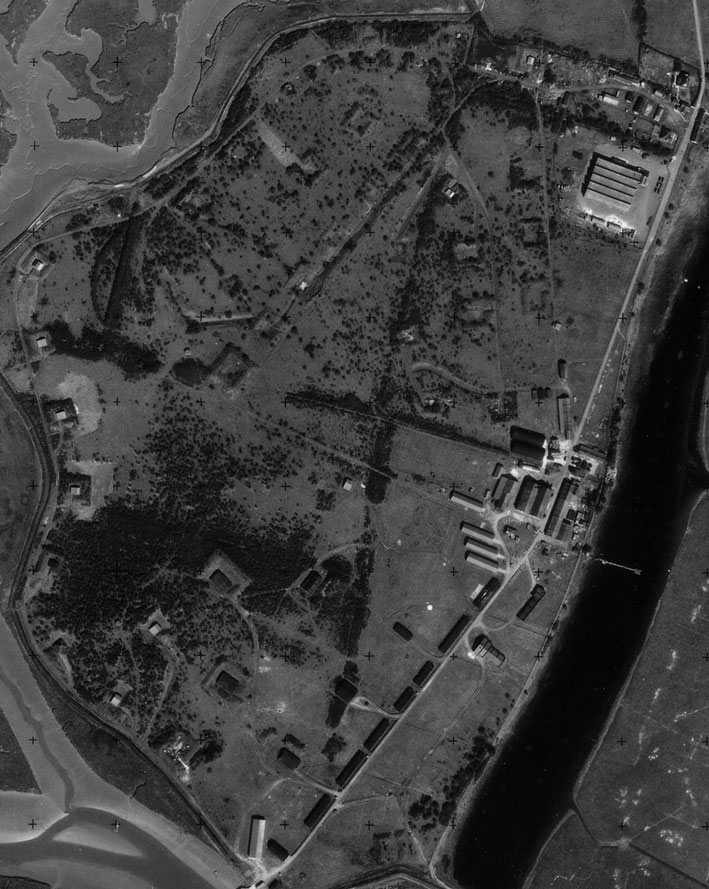 An RAF aerial photograph from 1953 clearly showing buildings and blast mounds all around the site.