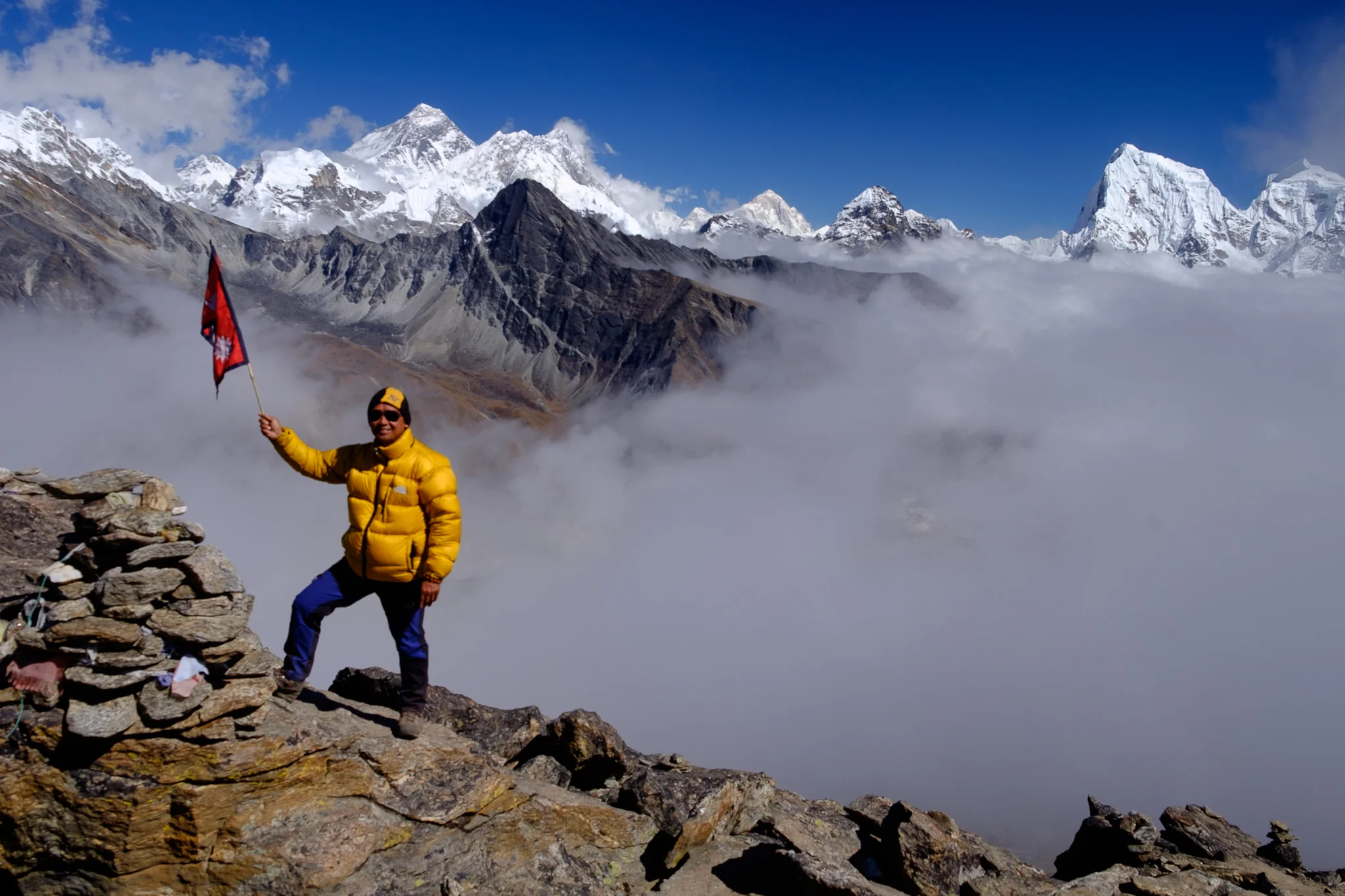 Our guide Sanu with a Nepalese flag claiming triumph
