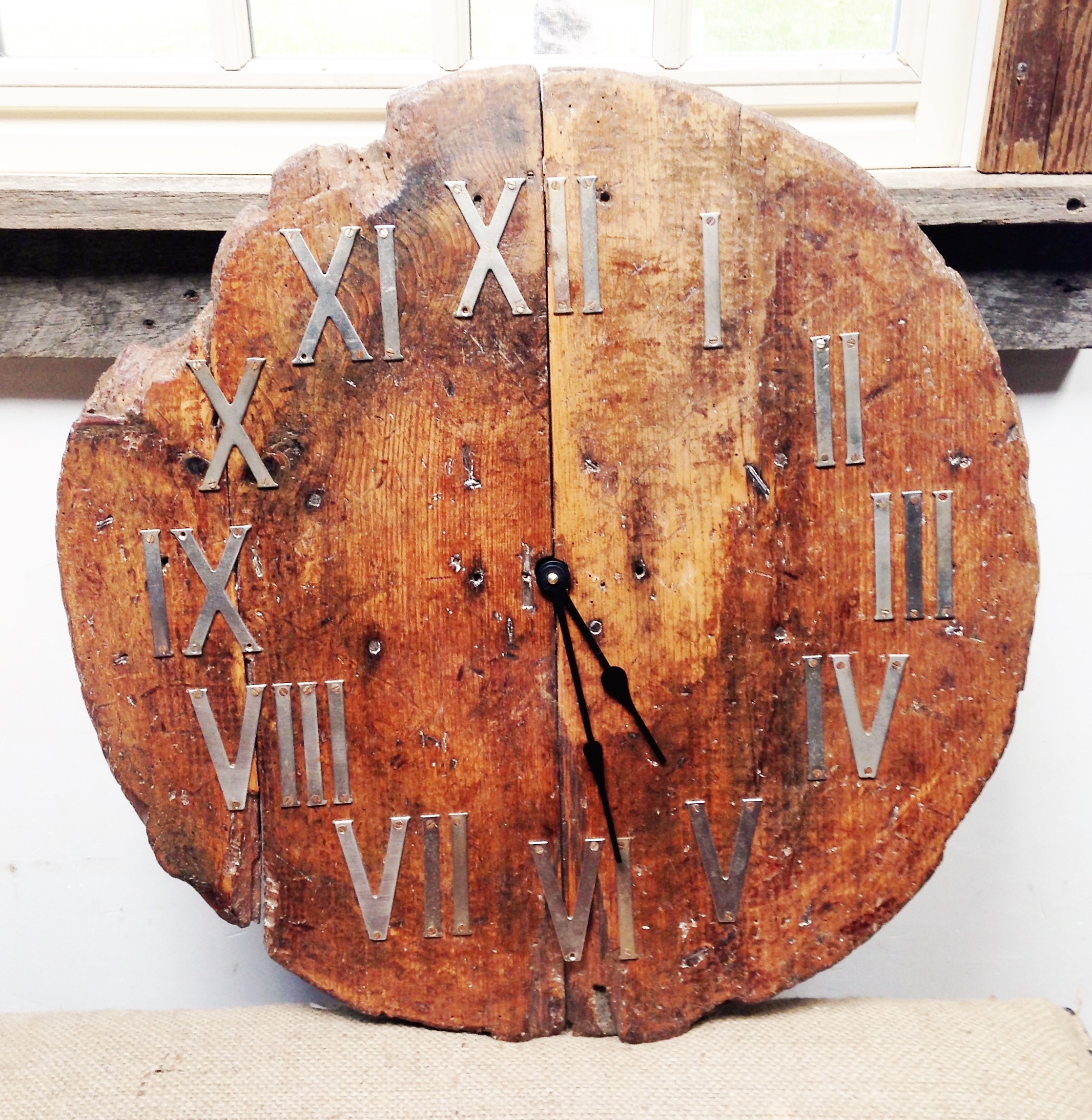 A fine example of re-purposing: a weathered barrel top becomes a one-of-a-kind clock.
