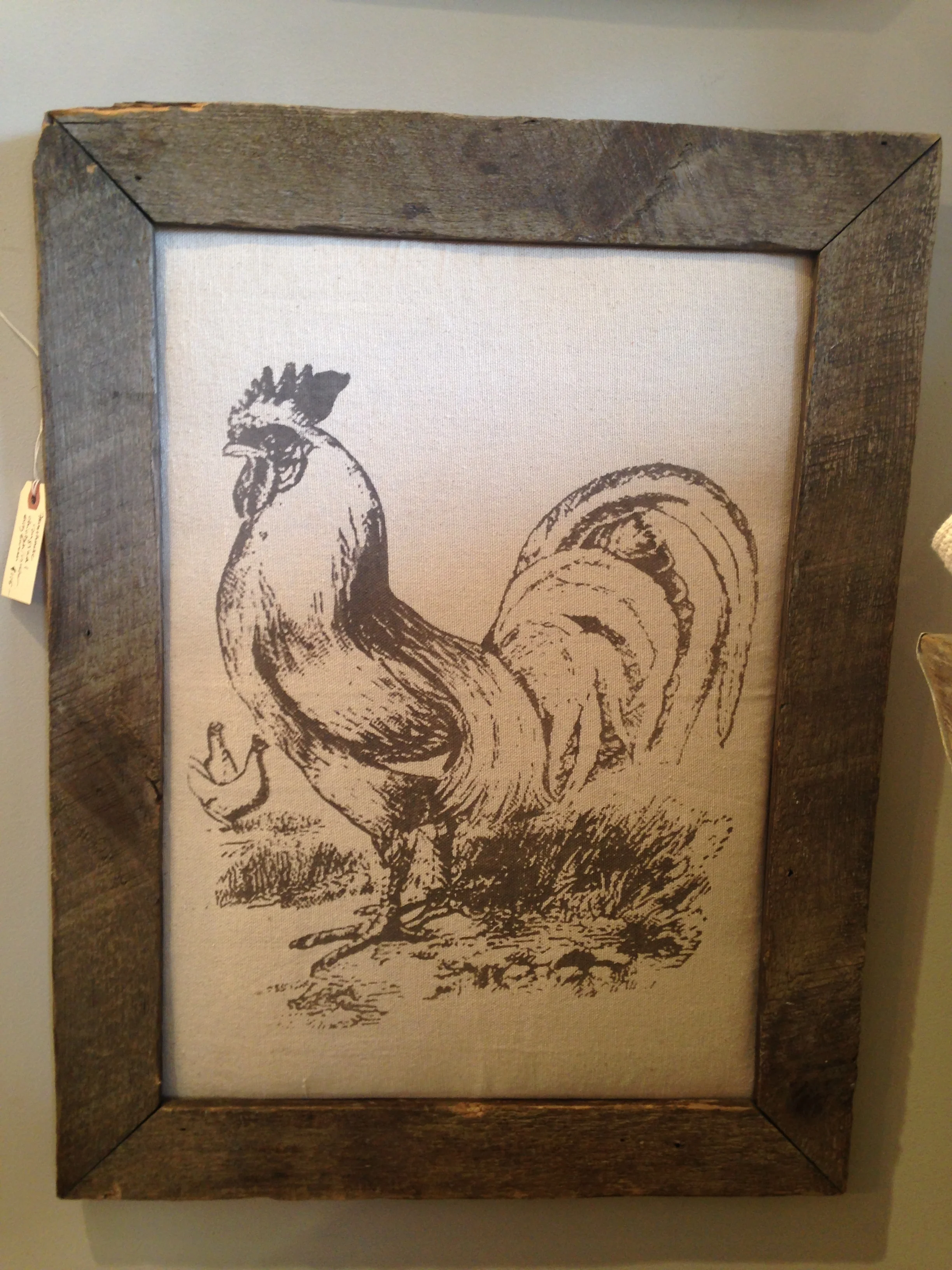The rooster is completely at home in his barn wood frame