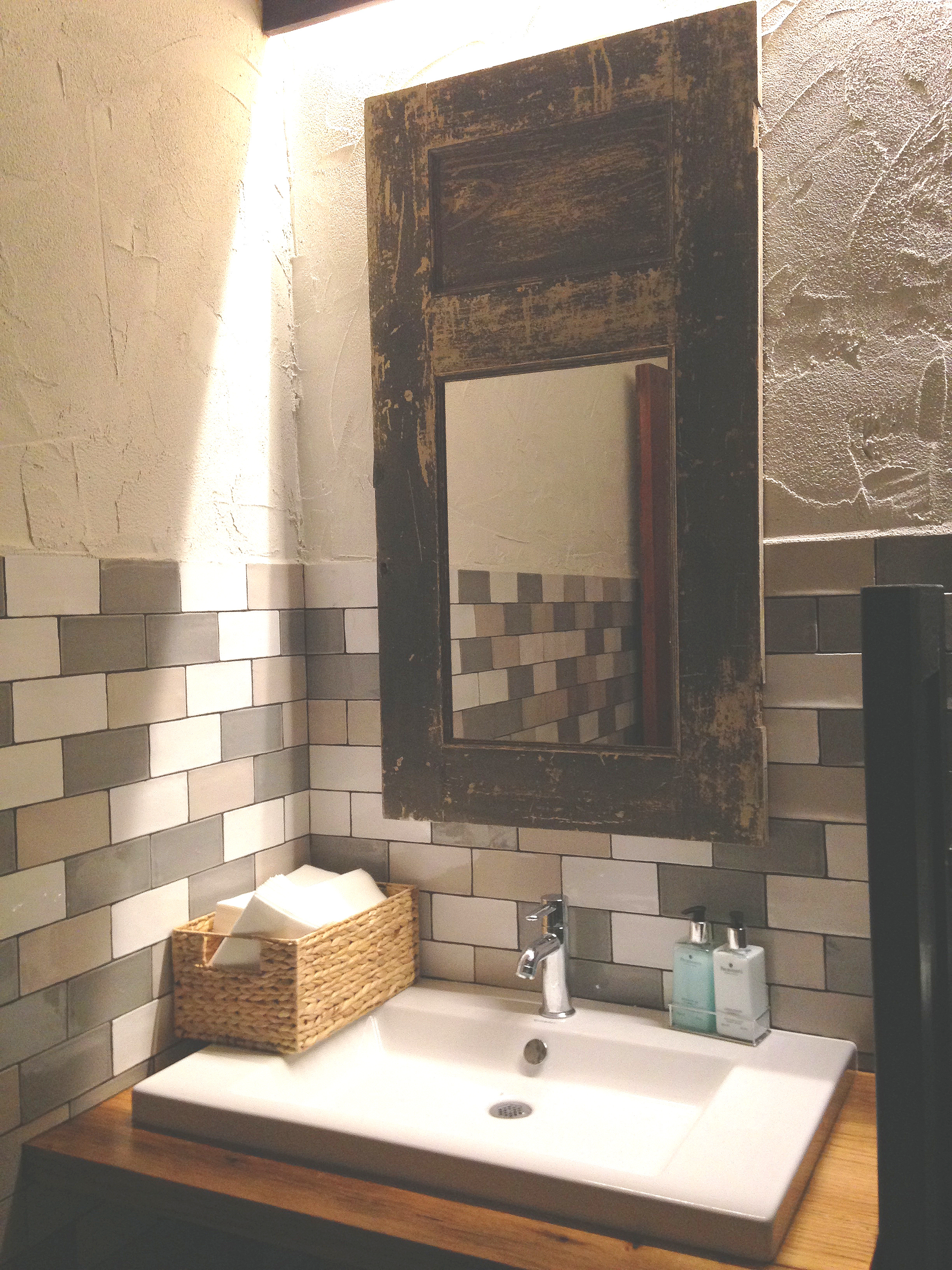 This recovered and re-purposed cupboard door becomes a statement piece in the “boys” room at Market Place restaurant.