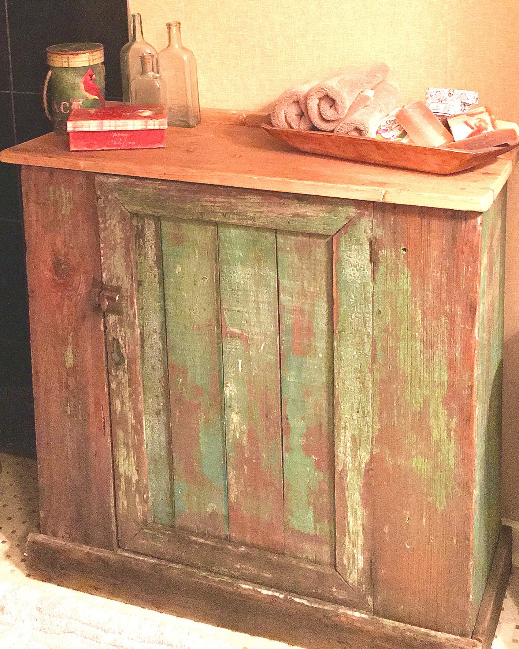 The old worn paint on this little cupboard made it the perfect piece to warm up a clients newly renovated bathroom.
