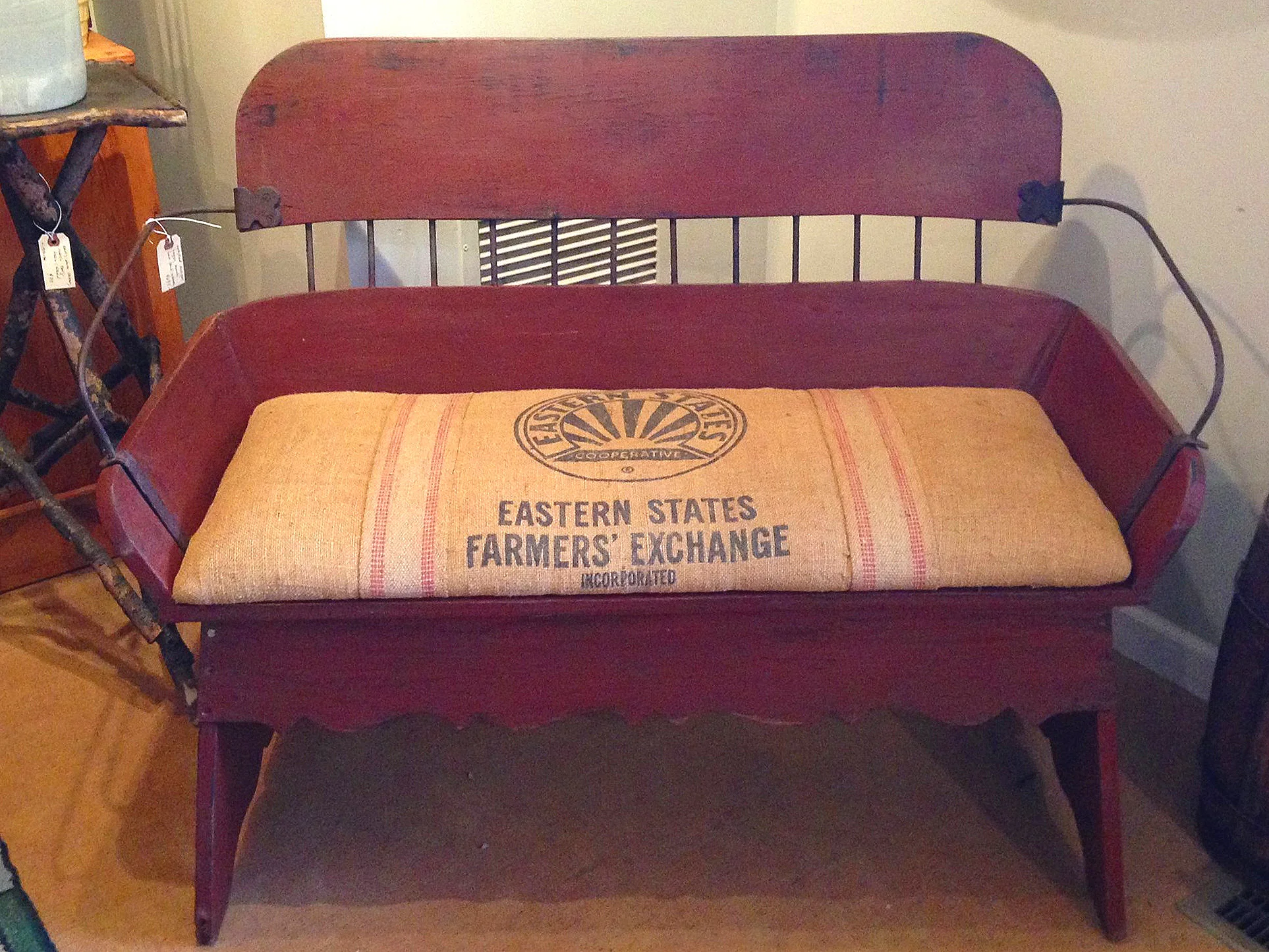 An old burlap feed sack makes an excellent cushion for this restored buggy bench.