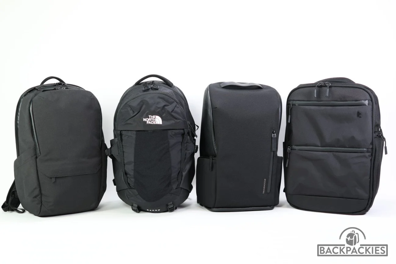 4 urban backpacks in a row. From left to right: Alpaka Elements Pro commuter backpack, The North Face Recon laptop backpack, Troubadour Pioneer city backpack, tomtoc TechPack-T73