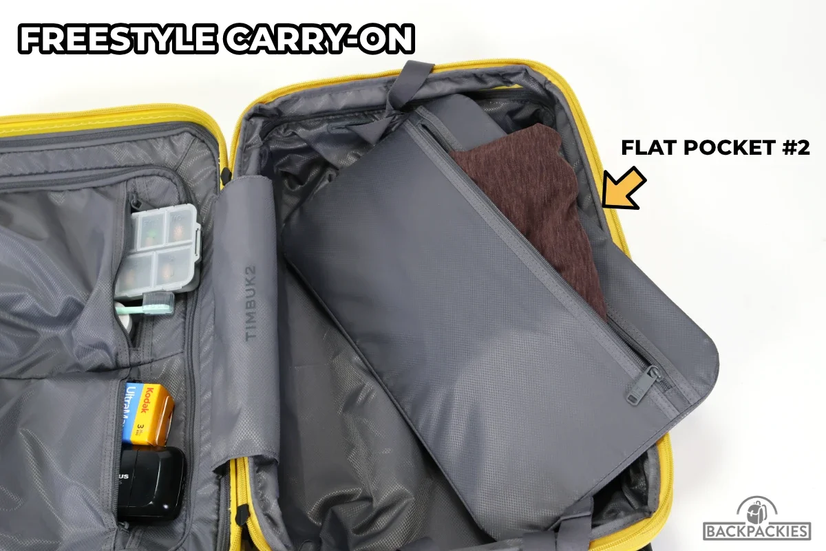 Timbuk2 FreeStyle carry-on compression board pocket showing flat zippered pocket for clothing organization