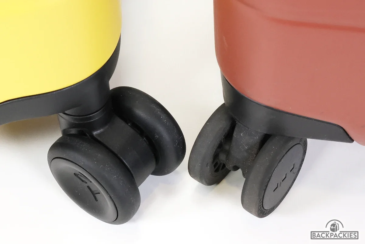 Timbuk2 FreeStyle carry-on wheels vs Monos carry-on wheels comparison showing Timbuk2's thicker rubber wheel design