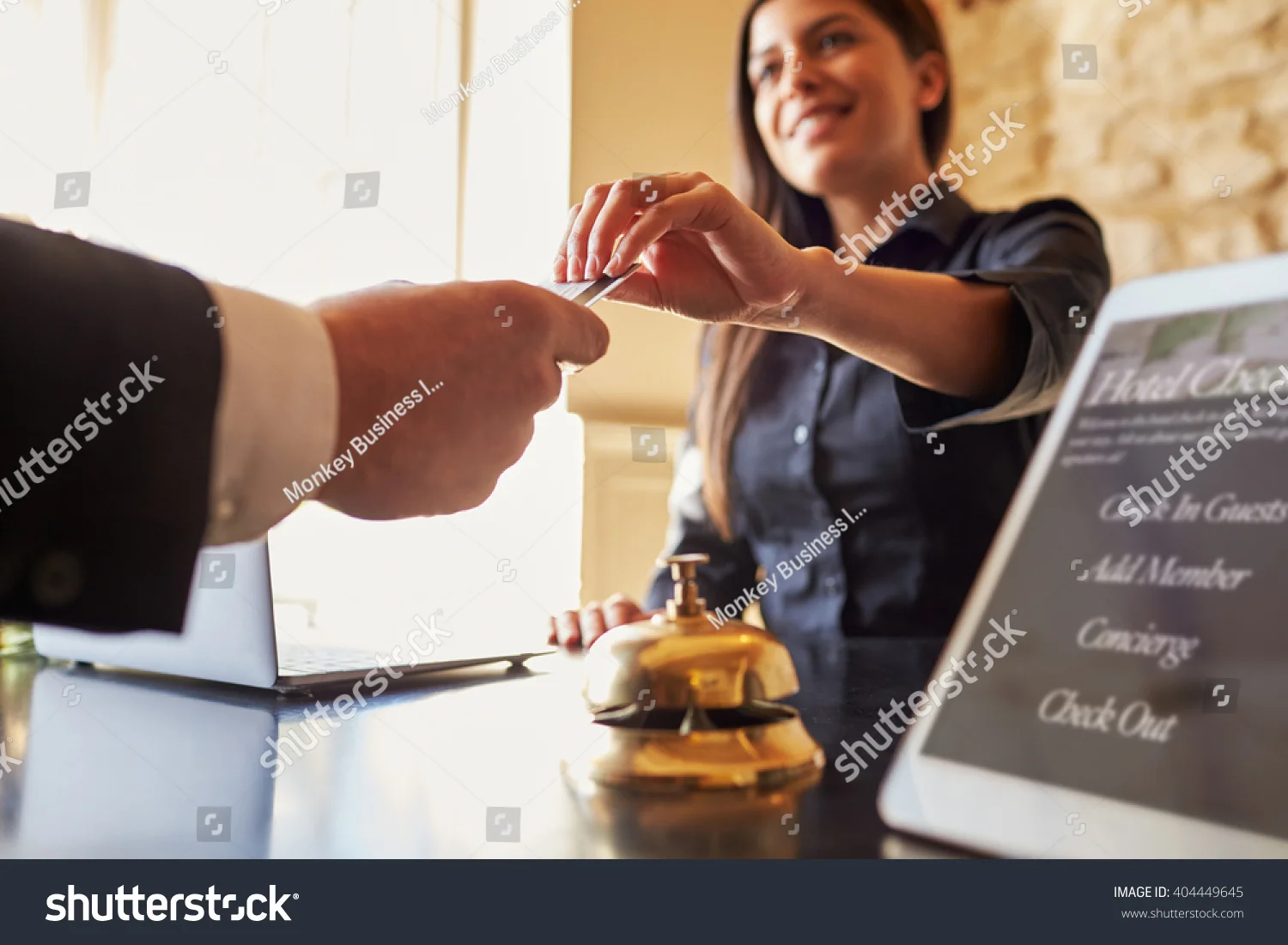 stock-photo-guest-takes-room-key-card-at-check-in-desk-of-hotel-close-up-404449645.jpg